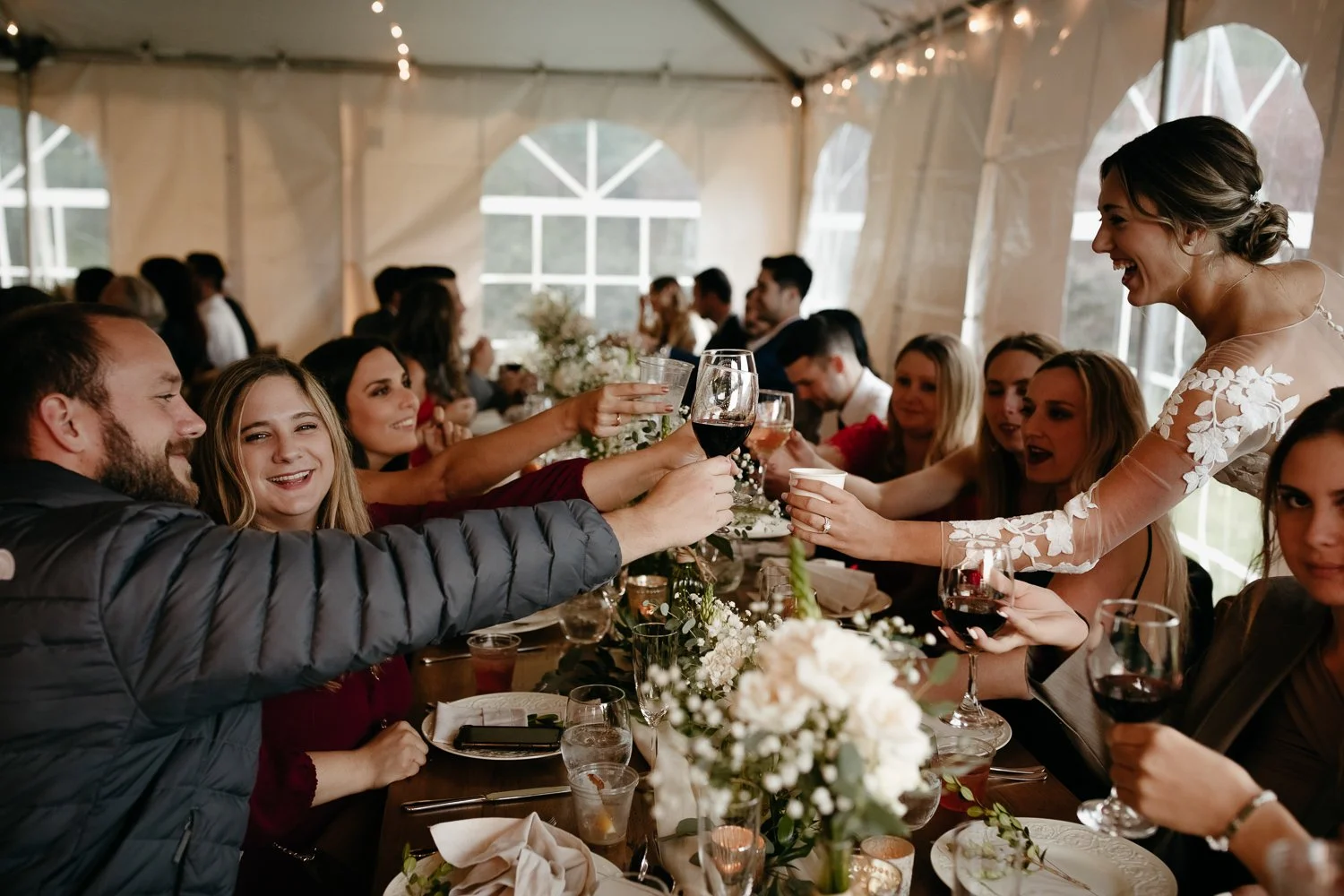 Bride toasting with friends and family during the reception at Windrift Hall