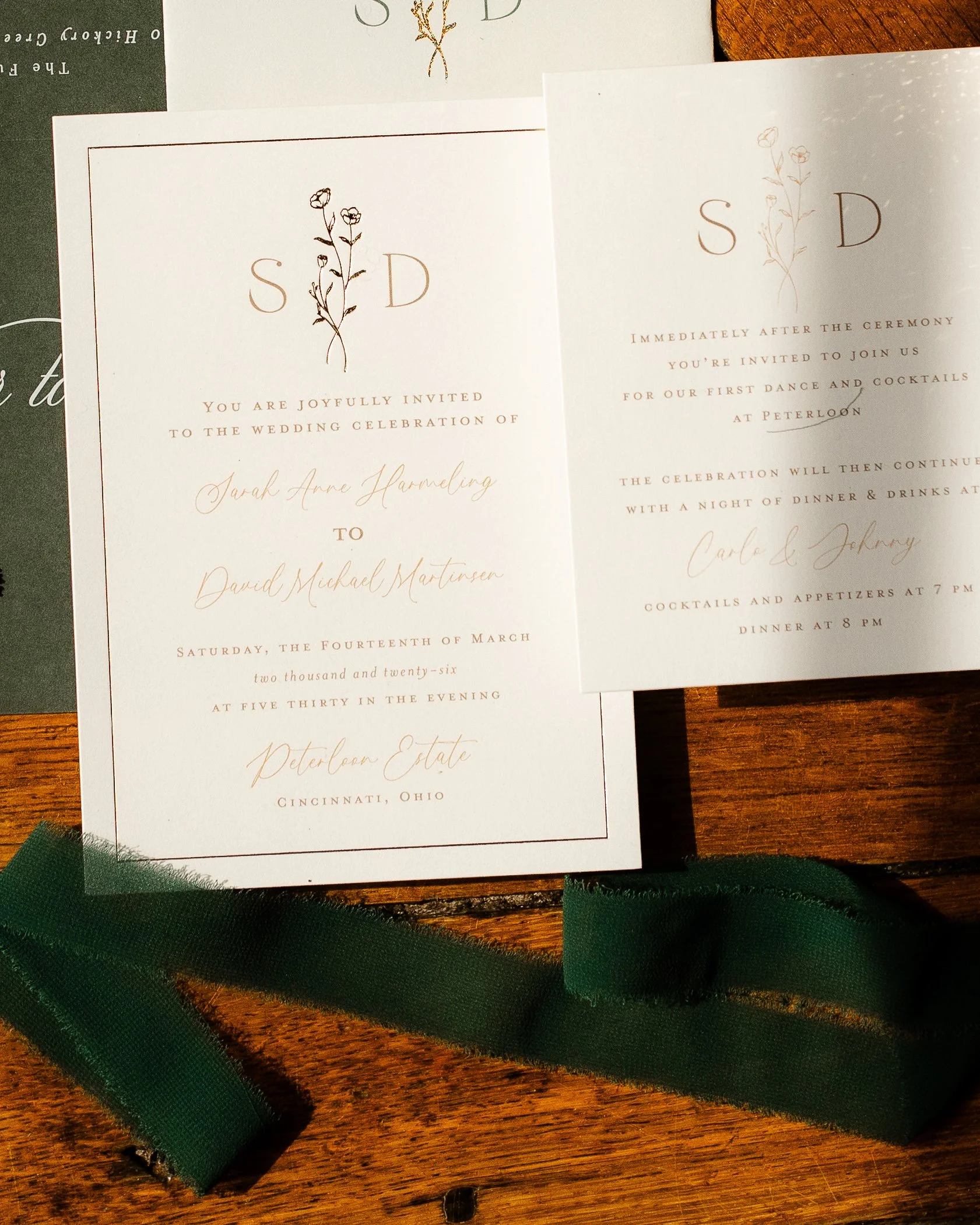 Elegant wedding invitation suite with soft neutral tones and green accents