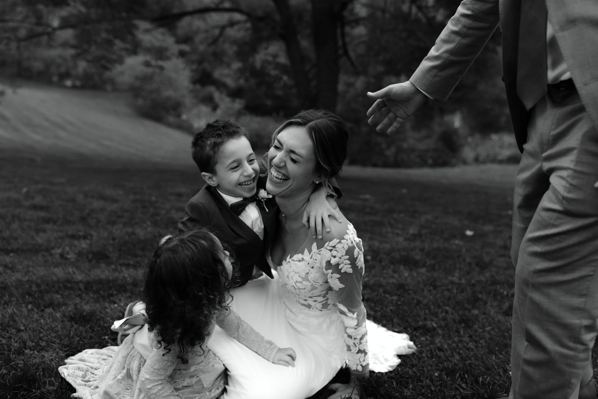 Bride laughing with young family members during a candid moment at Windrift Hall