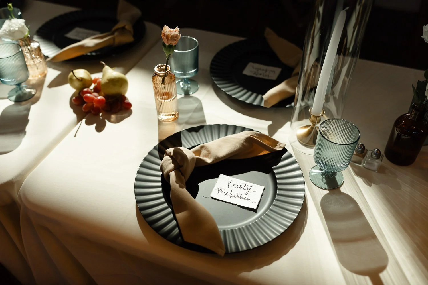 Wedding reception place setting with fruit accents, candles, and soft natural light at Ivory Meadows in Dayton, Ohio