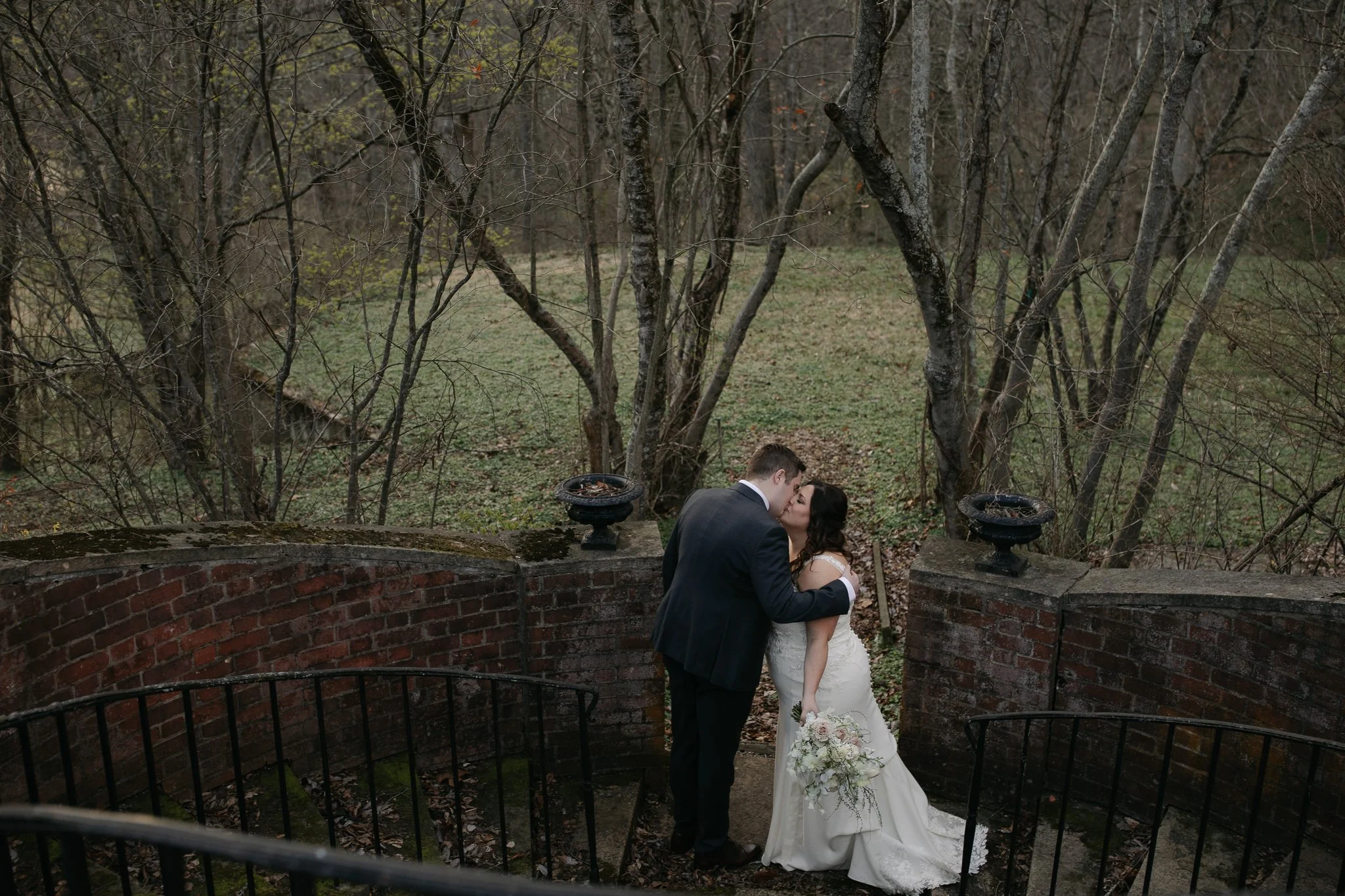 Couple embracing on stone steps at Peterloon Estate garden