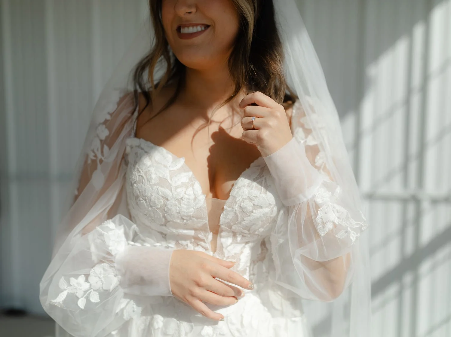 Close-up bridal portrait showing lace wedding dress and veil during getting ready at Ivory Meadows in Yellow Springs, Ohio.