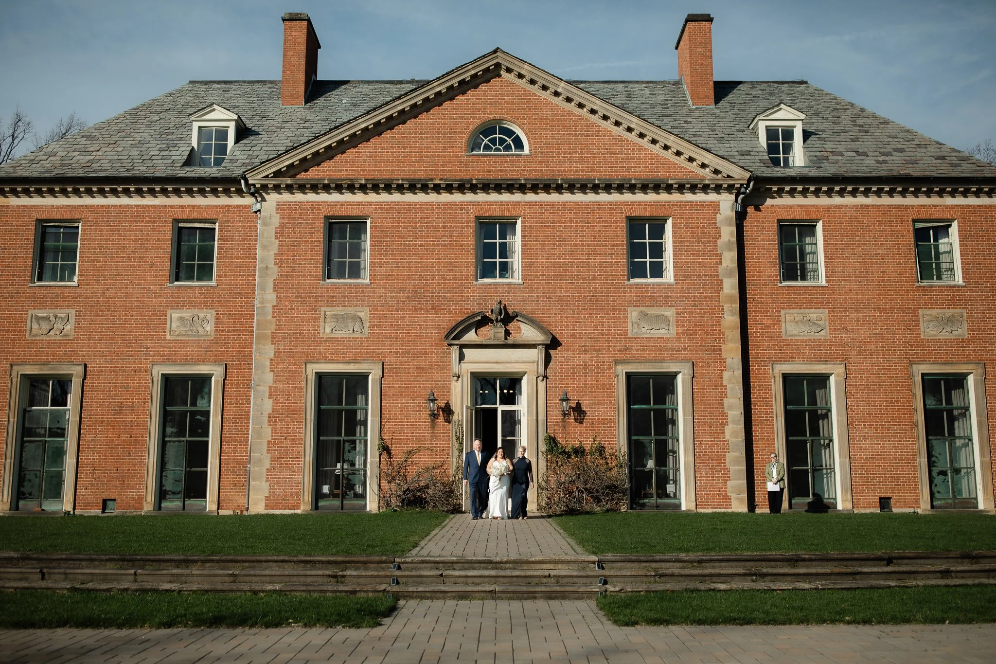 Wide view of ceremony set in front of Peterloon Estate