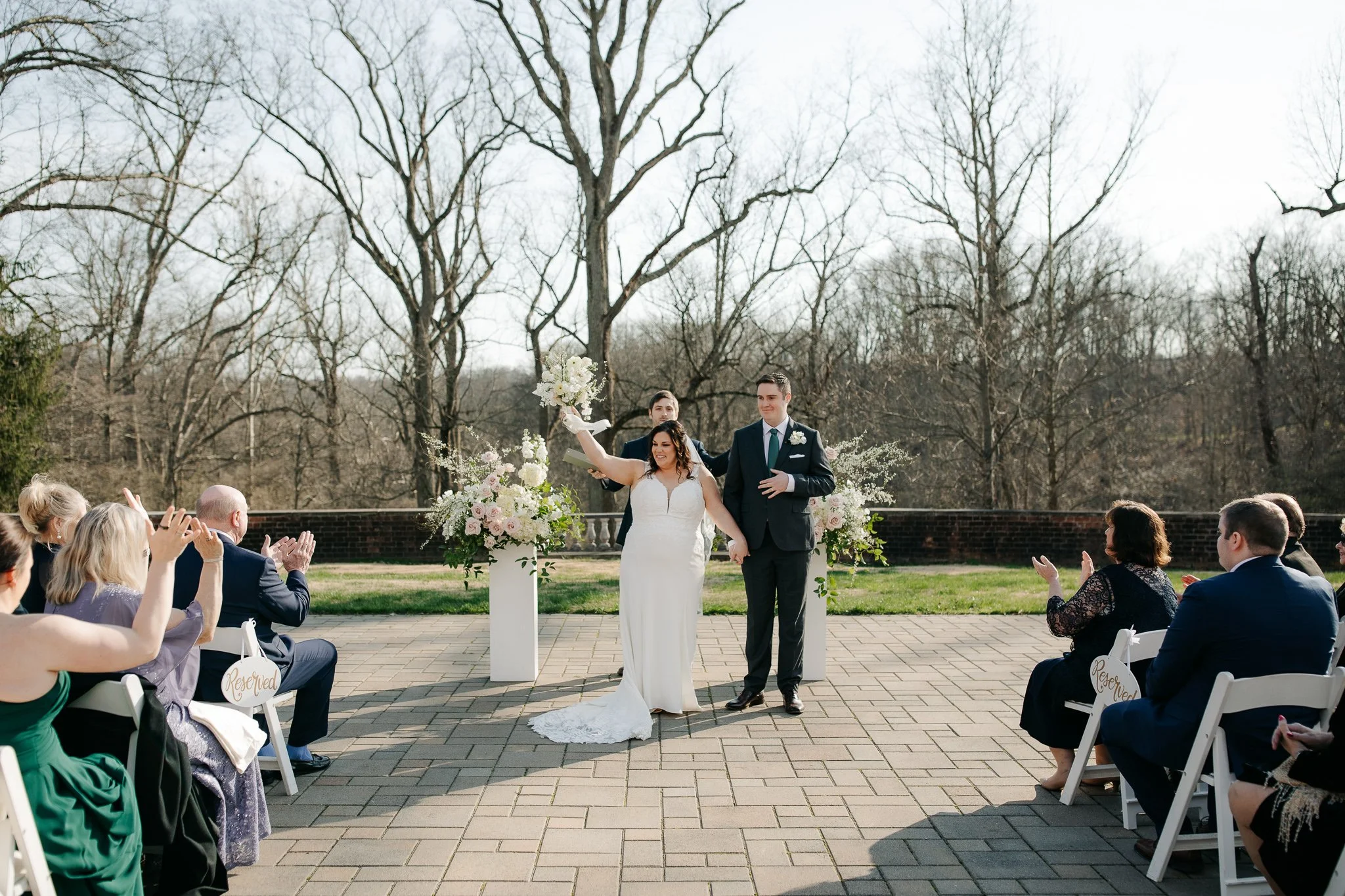 Bride and groom walking down aisle after ceremony as guests applaud