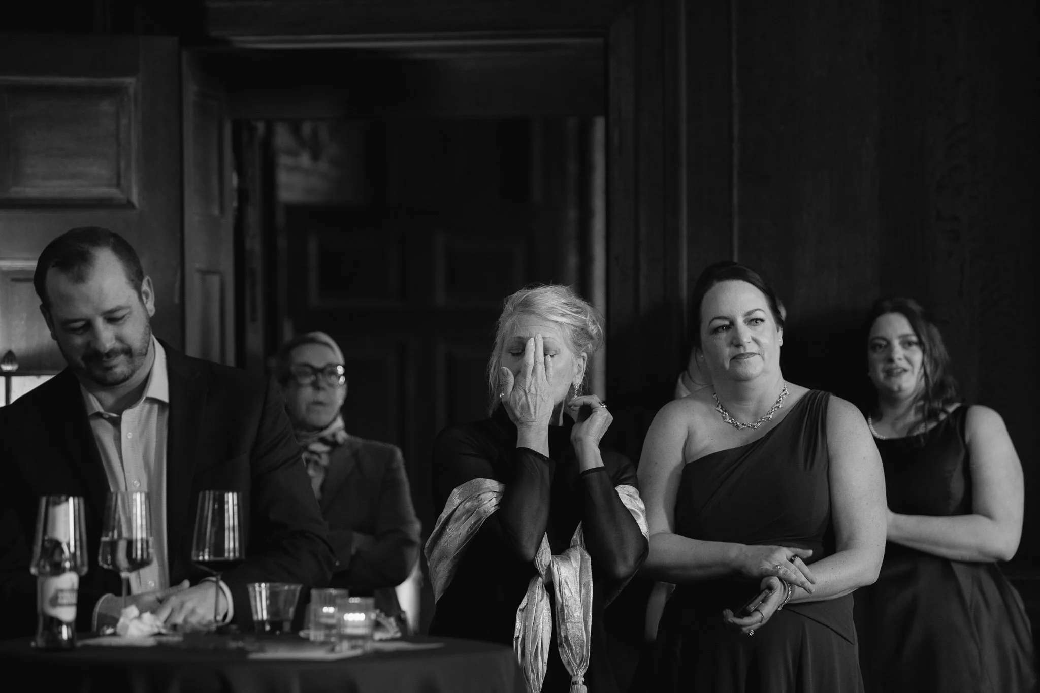 Guests reacting emotionally while watching dances in black and white