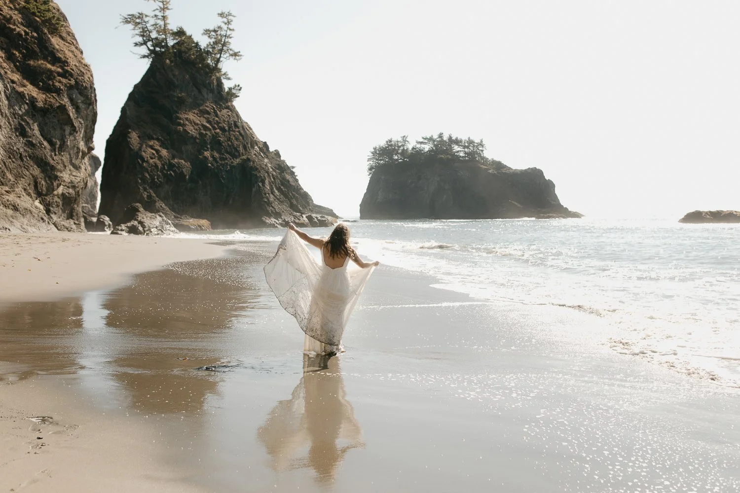 Bride walking along the Southern Oregon Coast beach in her wedding dress