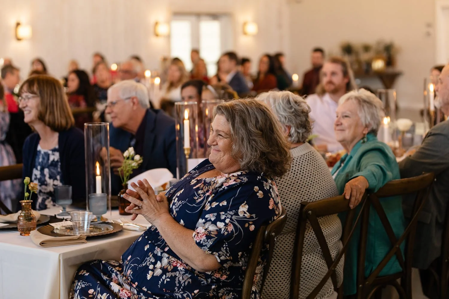 Wedding guests smiling and reacting during reception speeches at Ivory Meadows wedding venue in Dayton Ohio