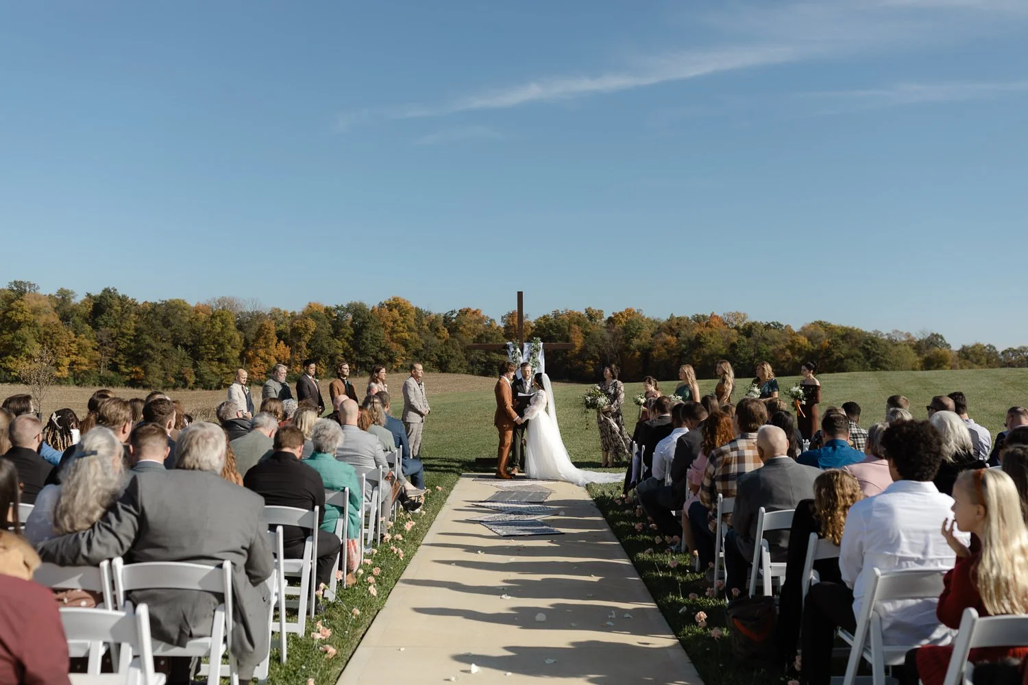 Outdoor wedding ceremony at Ivory Meadows near Dayton, Ohio with guests seated along the aisle