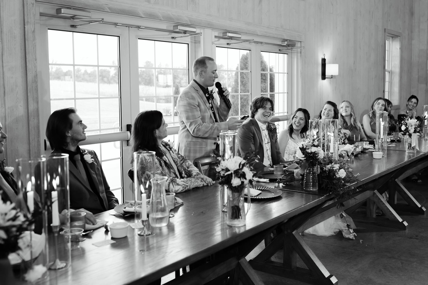 Wedding reception speeches at Ivory Meadows in Dayton, Ohio with the couple laughing at the head table