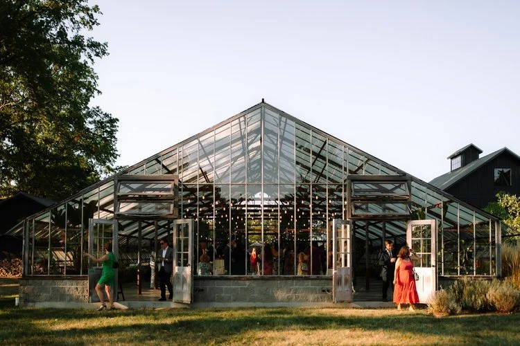 Glass greenhouse wedding reception near Columbus, Ohio with natural light and elegant table settings
