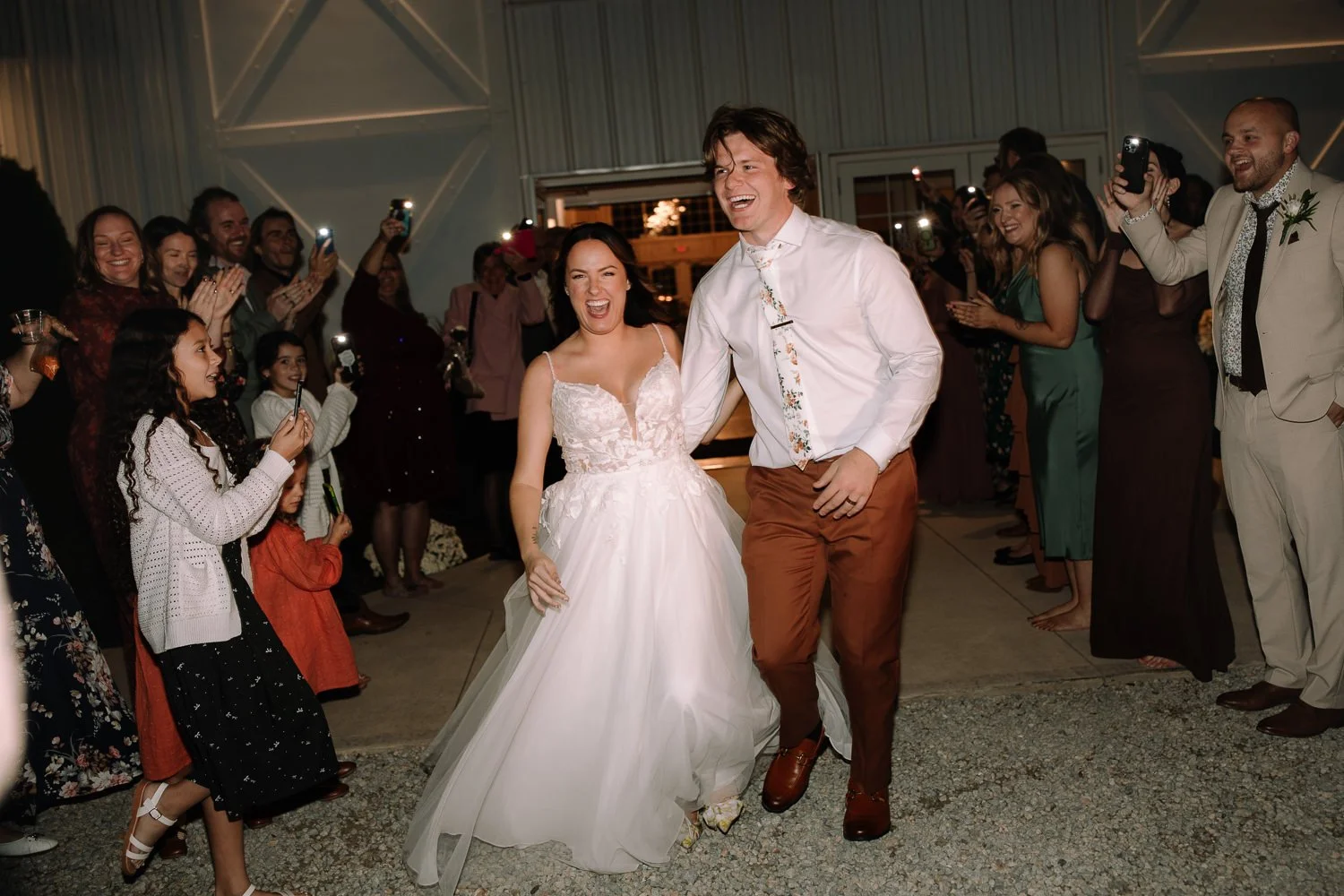 Bride and groom celebrating during their wedding night exit at Ivory Meadows in Dayton Ohio