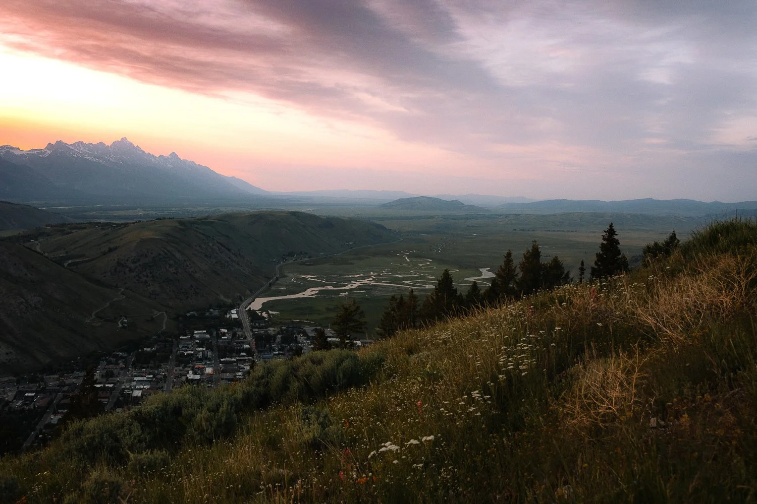 Sunset overlooking Jackson Hole valley and the Teton Range from a hillside viewpoint
