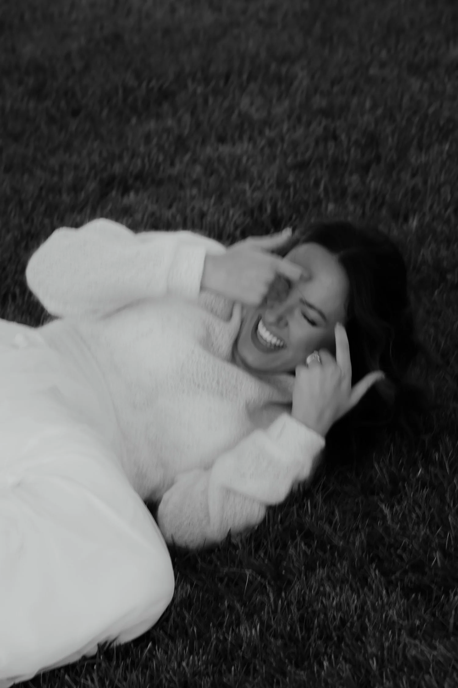 Candid black and white portrait of a bride laughing during evening wedding portraits at Ivory Meadows in Dayton, Ohio.