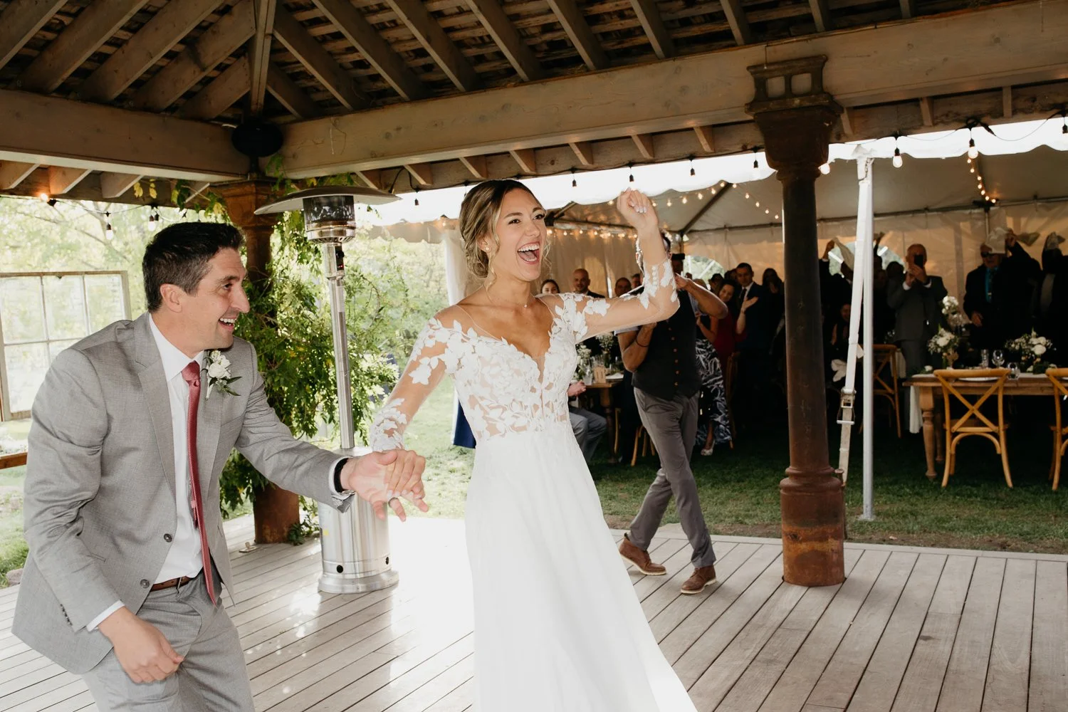 Bride and groom entering the dance floor during their reception at Windrift Hall