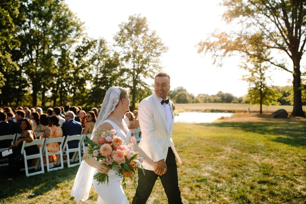 Bride and groom walking hand in hand after ceremony at Oak Grove at Jorgensen Farms near Columbus, Ohio