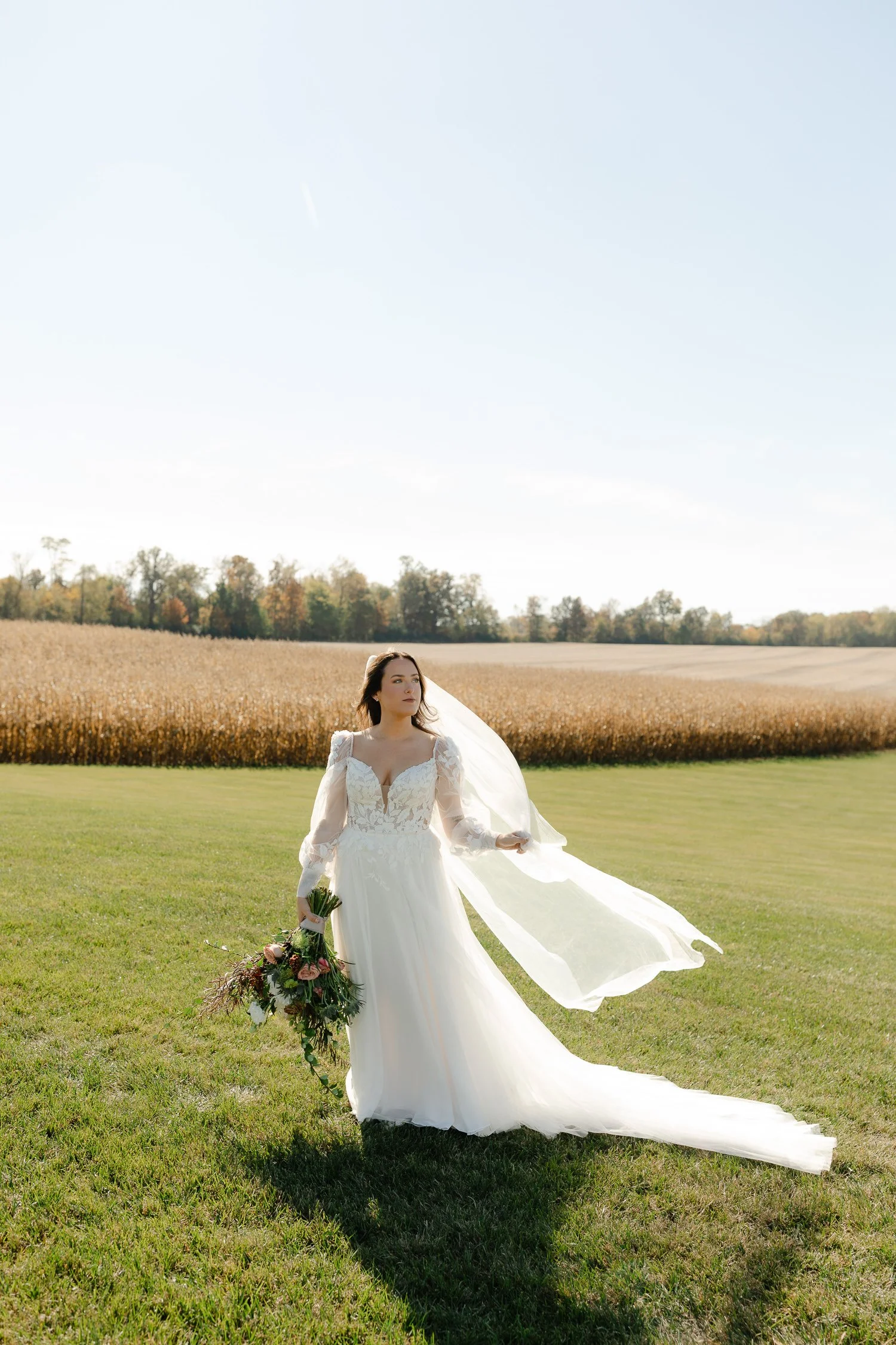 Full-length bridal portrait in an open field at Ivory Meadows in Yellow Springs, Ohio during an October wedding.