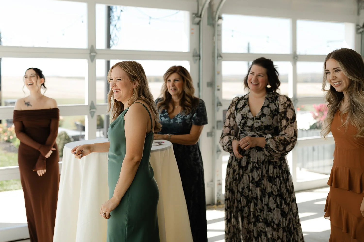 Bridesmaids watching and reacting during bridal getting ready moments at Ivory Meadows in Yellow Springs, Ohio.