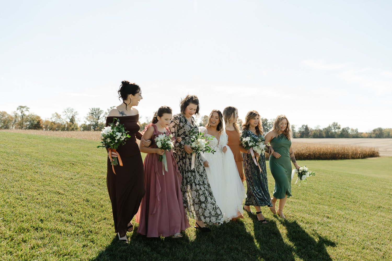 Bride walking with her bridesmaids during portraits at an Ivory Meadows wedding in Yellow Springs, Ohio.