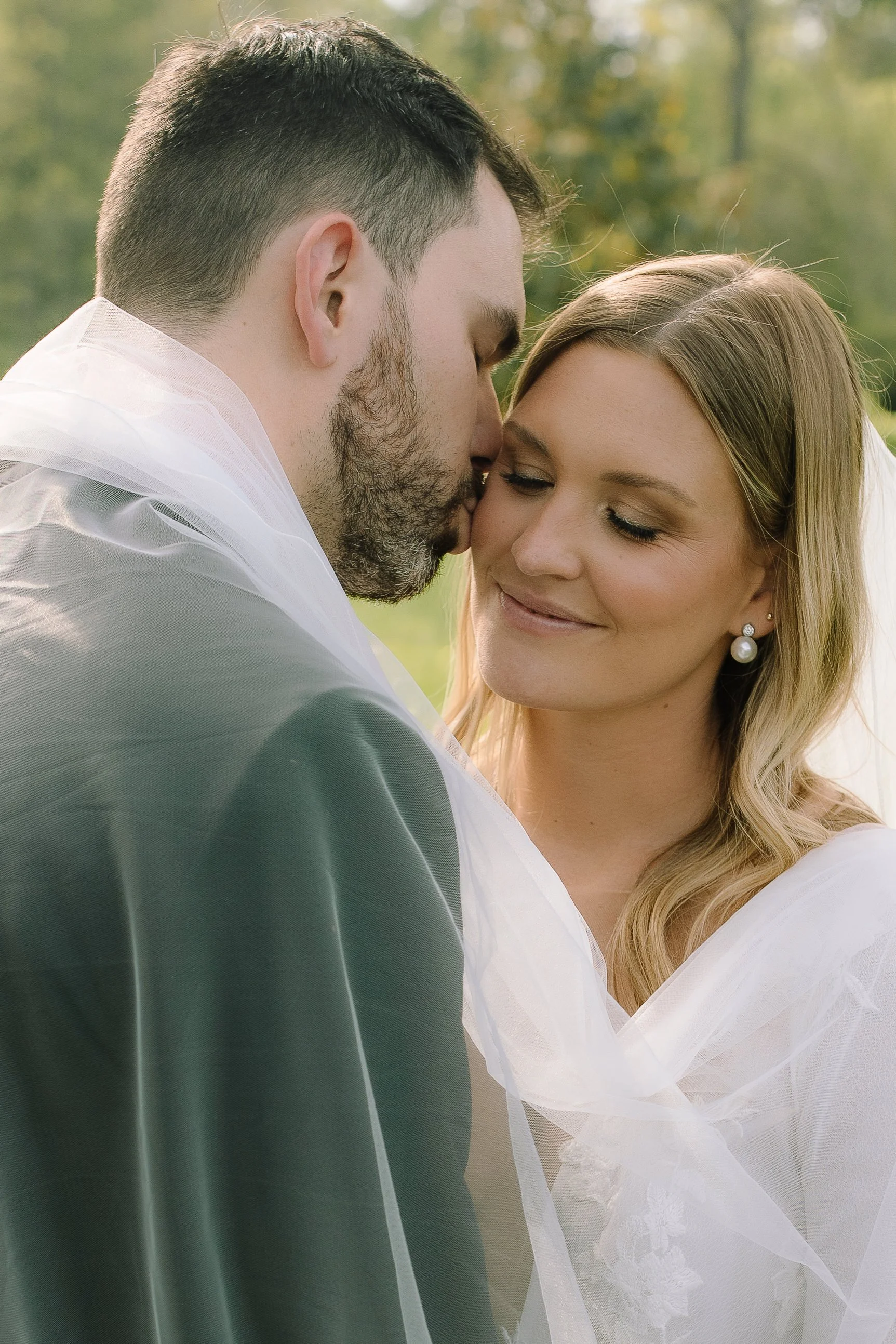 Close-up portrait of bride and groom in soft evening light during their wedding at Jorgensen Farm The Gardens in Columbus.