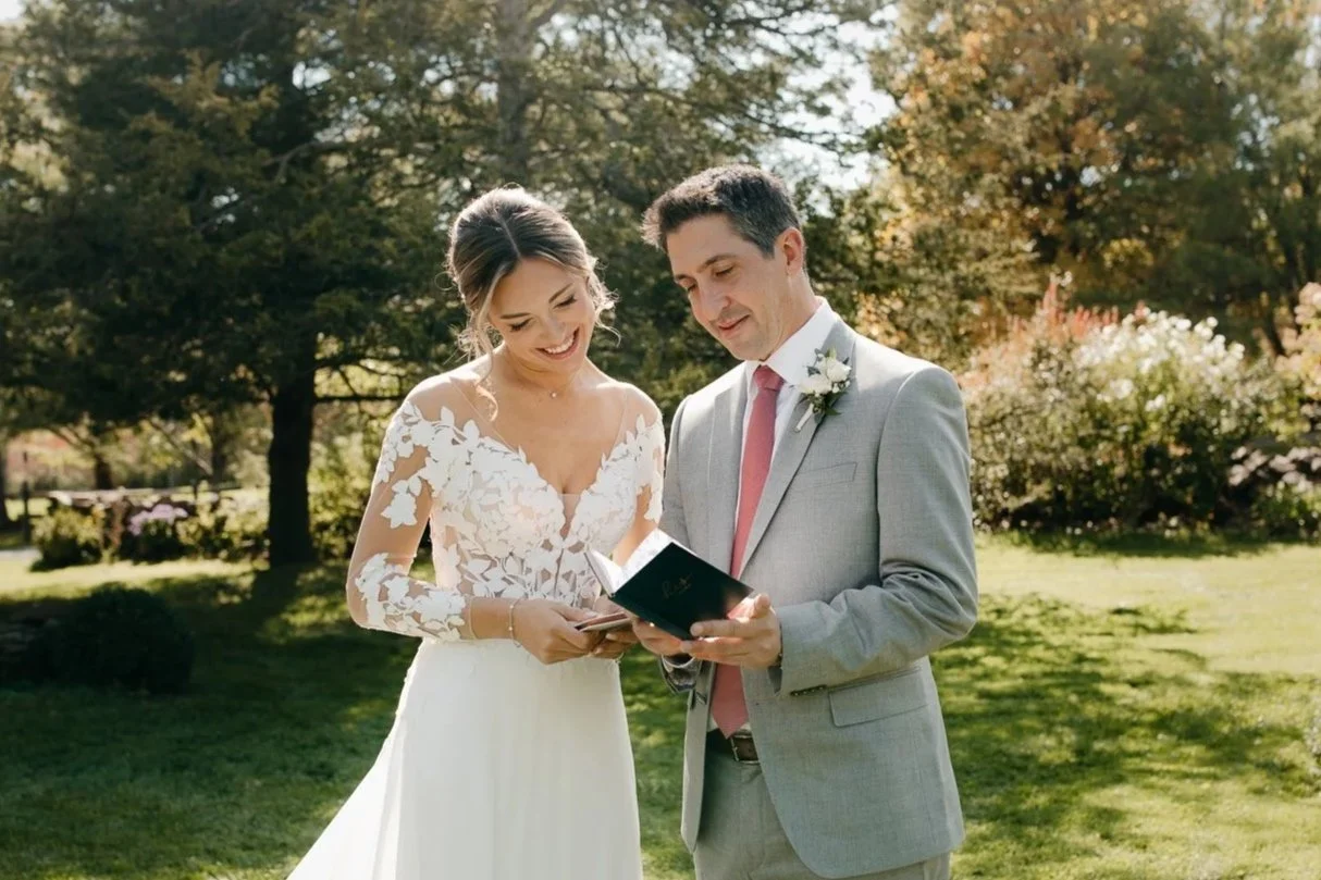 Bride and groom reading their private vows together before their Windrift Hall wedding ceremony