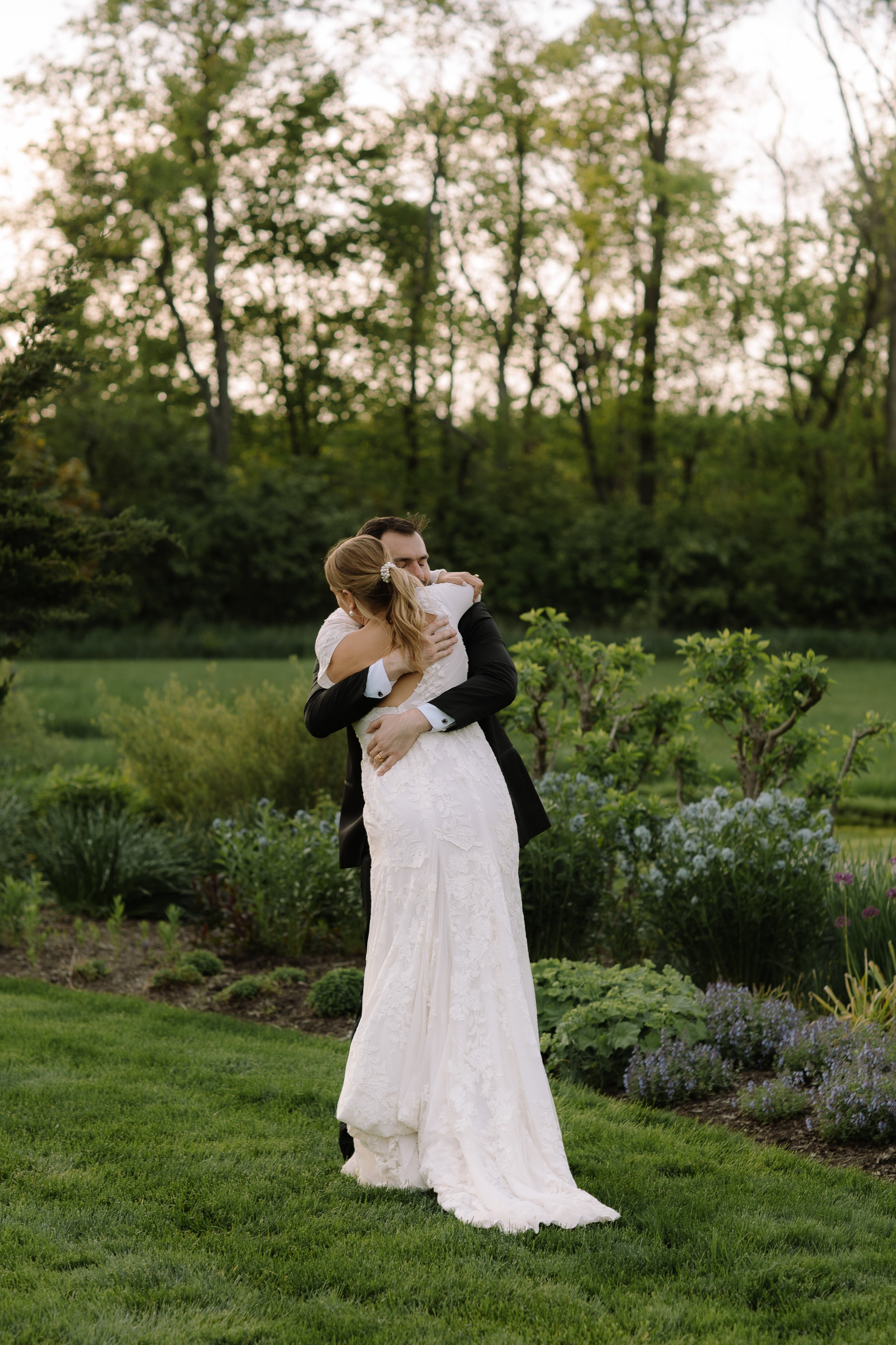 Bride and groom embracing in the gardens at Jorgensen Farm The Gardens in Columbus during golden hour.