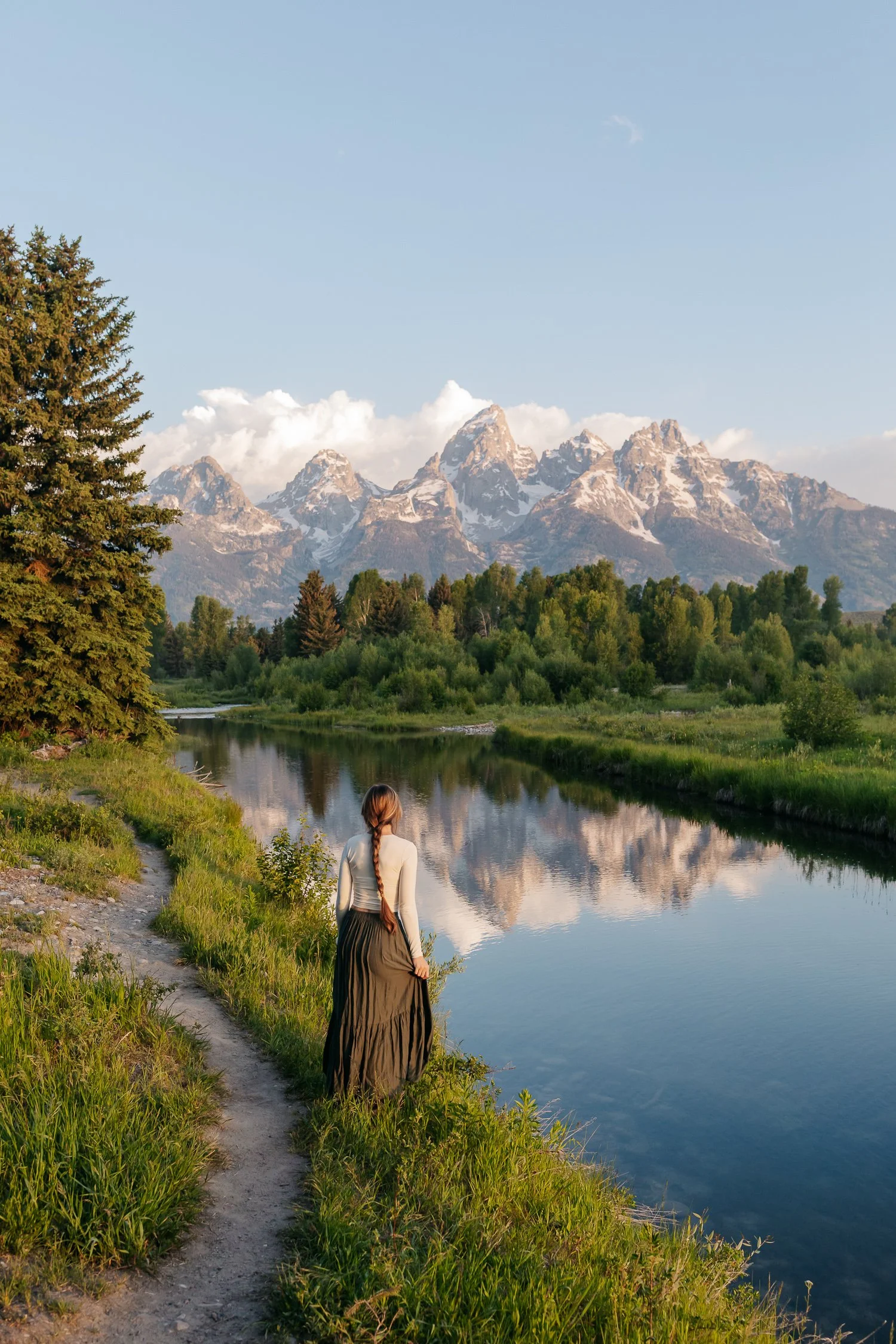 Morning light reflecting on the Snake River with the Grand Teton mountain range in the background.