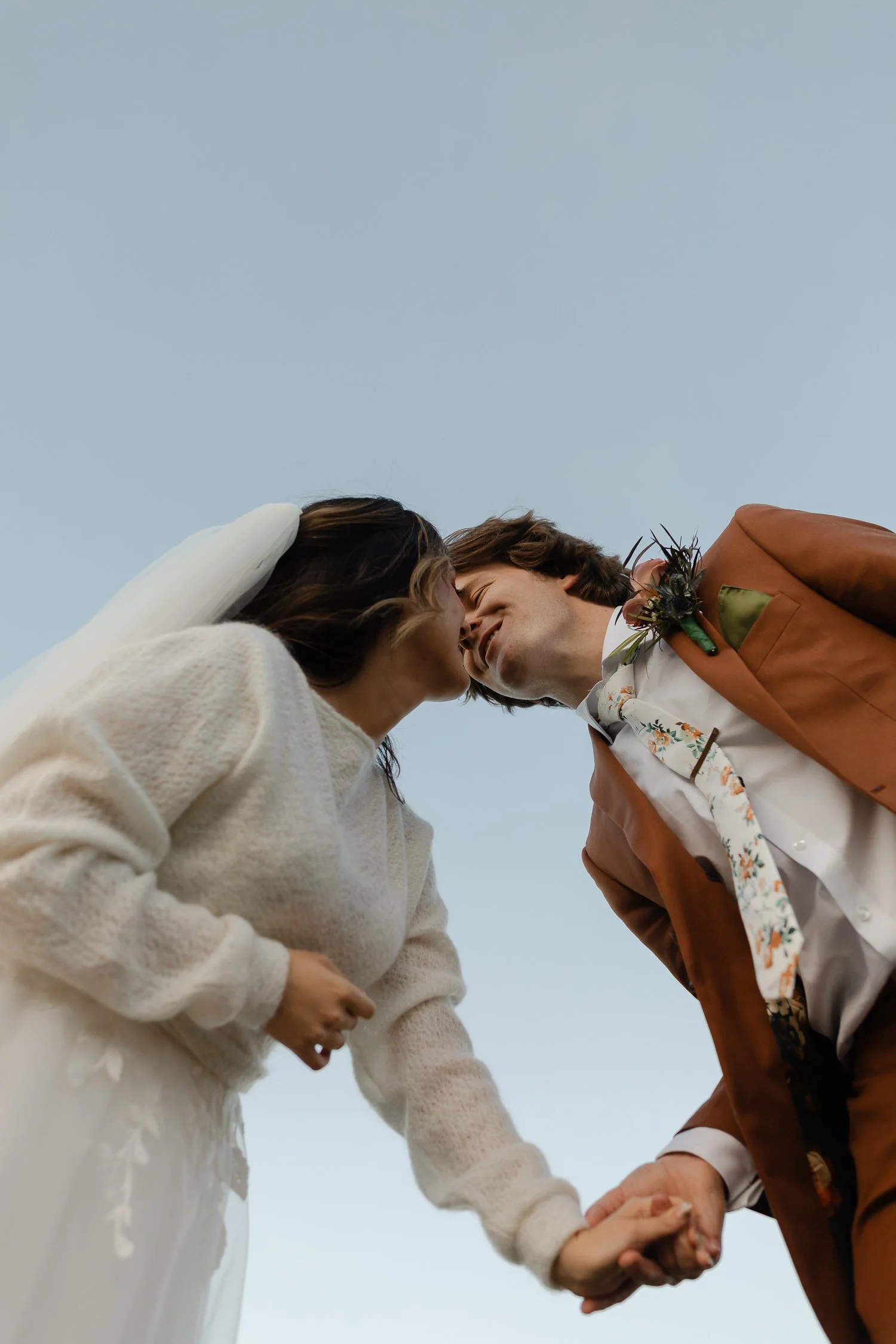 Bride and groom share a joyful kiss during their October wedding at Ivory Meadows in Yellow Springs, Ohio.
