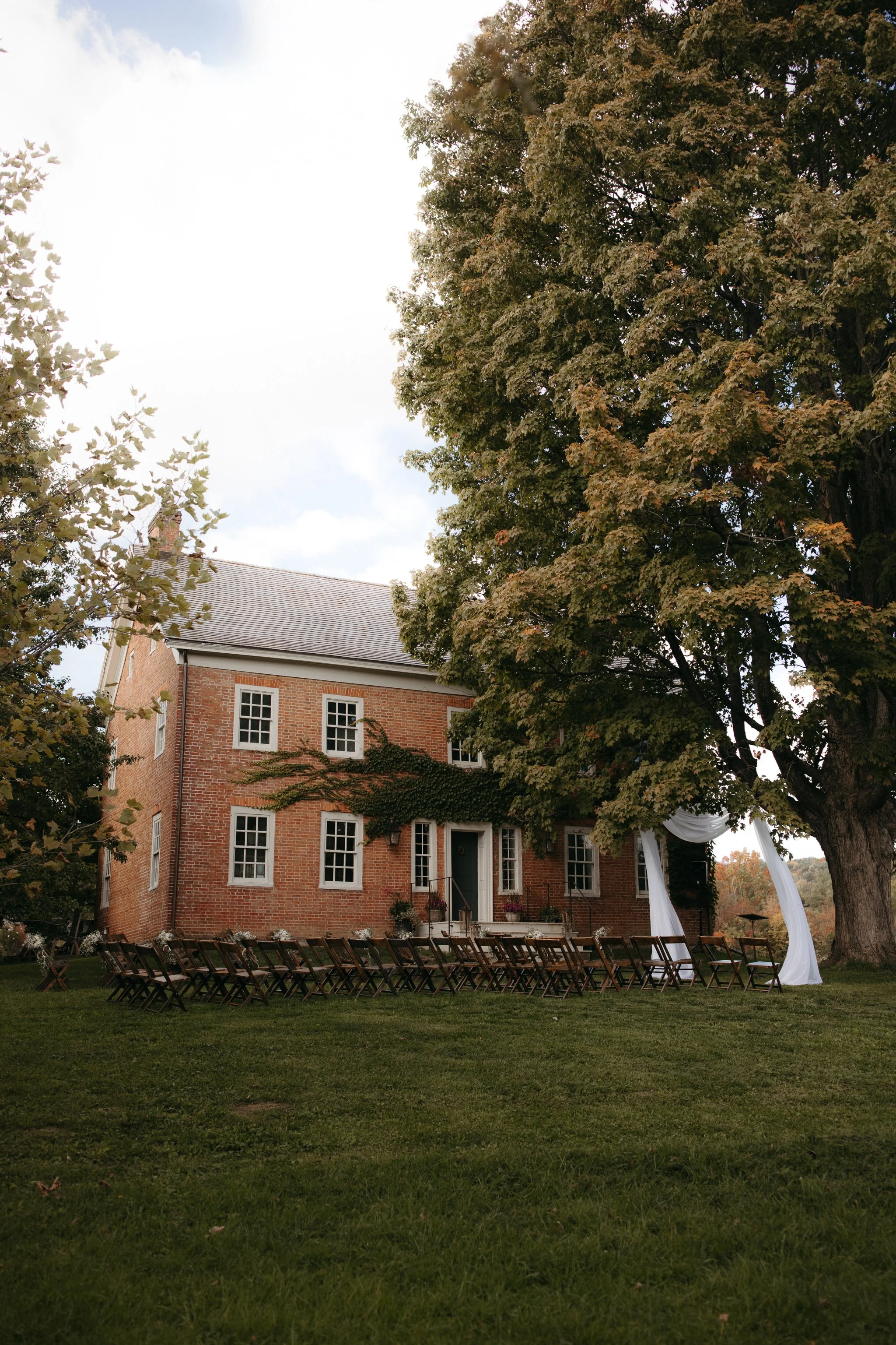 Outdoor wedding ceremony setup at Windrift Hall surrounded by trees and open landscape in the Hudson Valley