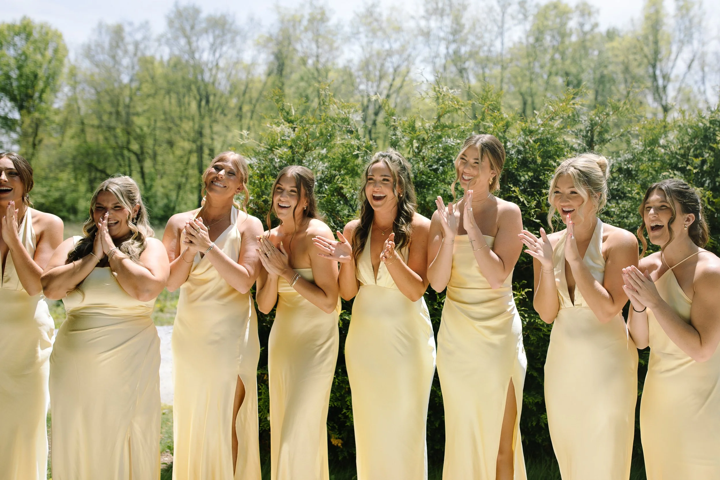 Bridesmaids reacting with laughter and tears during the bride’s first look at Jorgensen Farm The Gardens in Columbus.