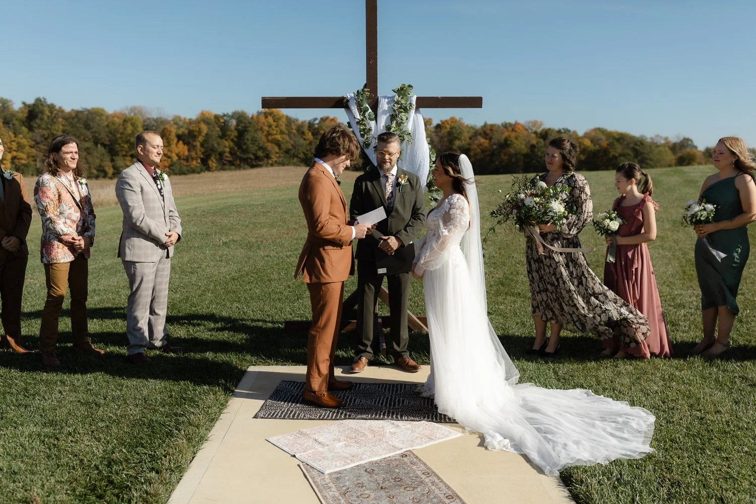 Bride and groom exchanging vows during a fall outdoor wedding at Ivory Meadows in Dayton, Ohio