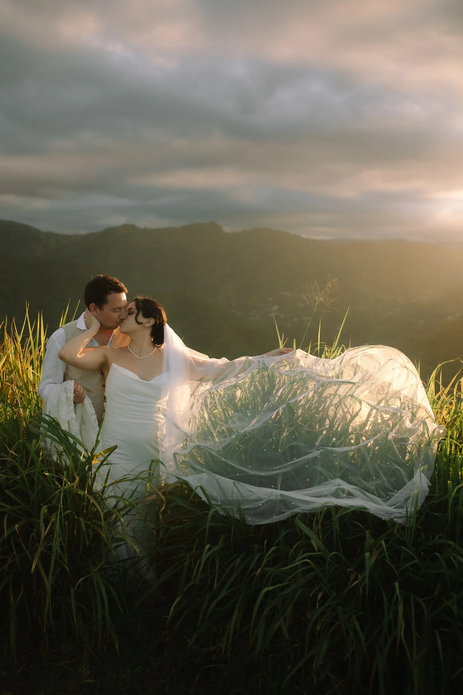 Bride and groom together on a mountain ridge under dramatic clouds at Cerro Mime