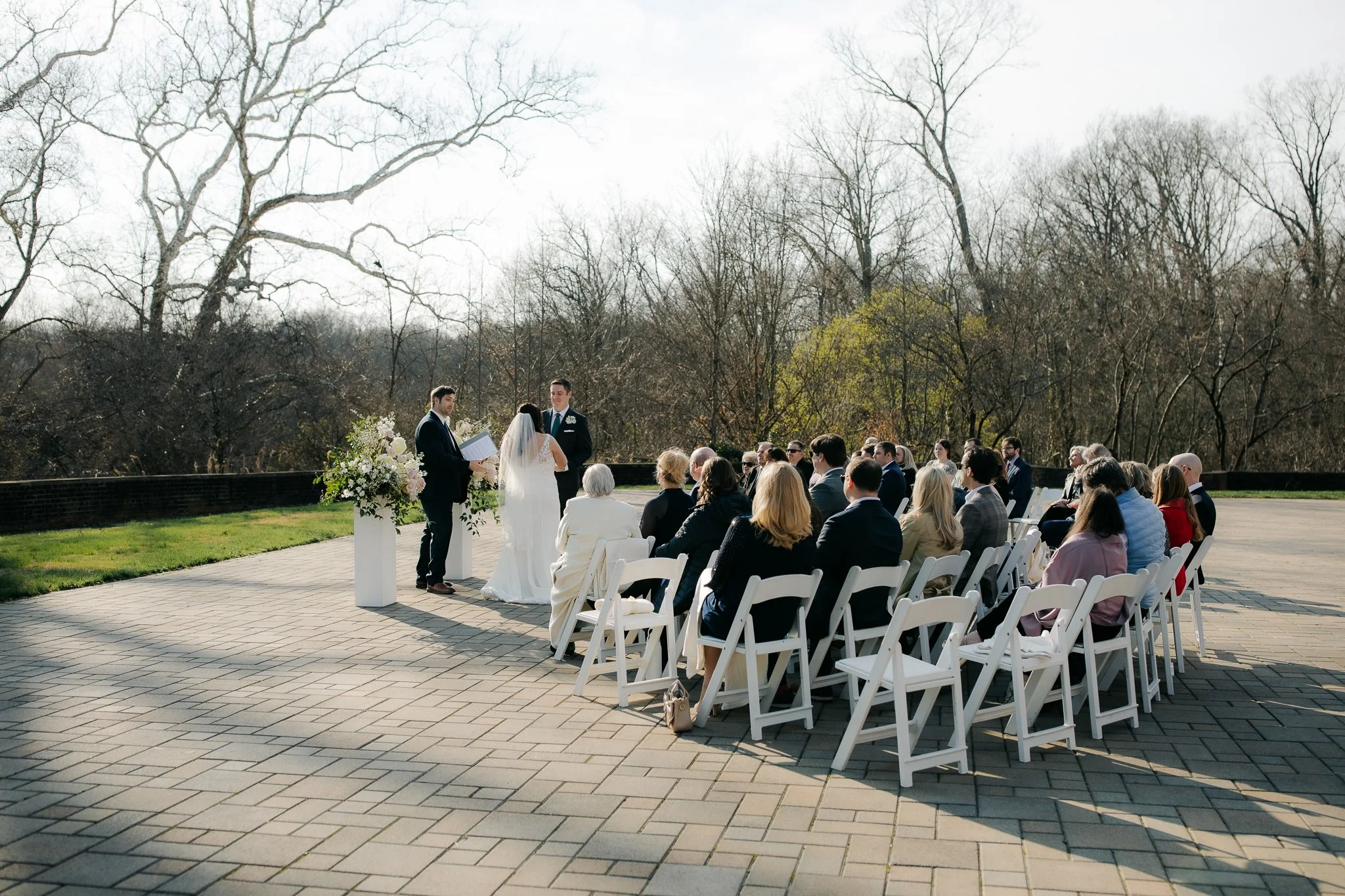 Outdoor ceremony with rows of guests on terrace at Peterloon Estate