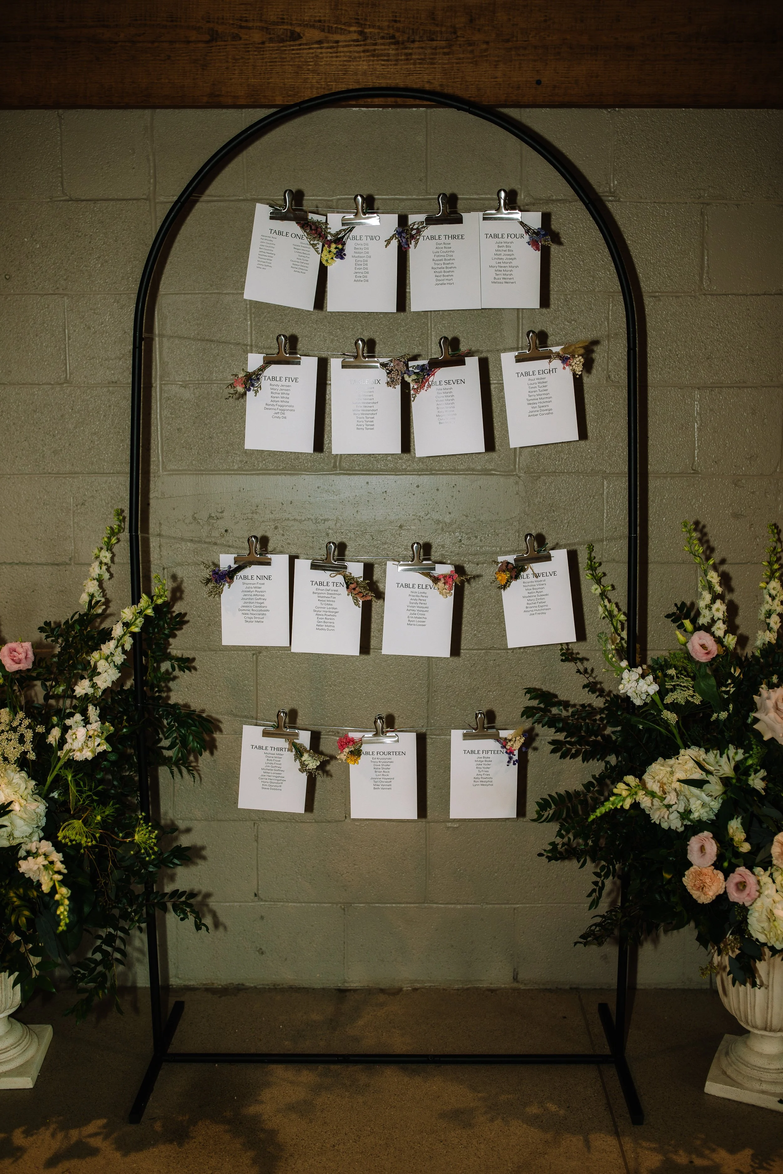 Wedding seating chart display with floral accents inside the historic barn at Jorgensen Farms.