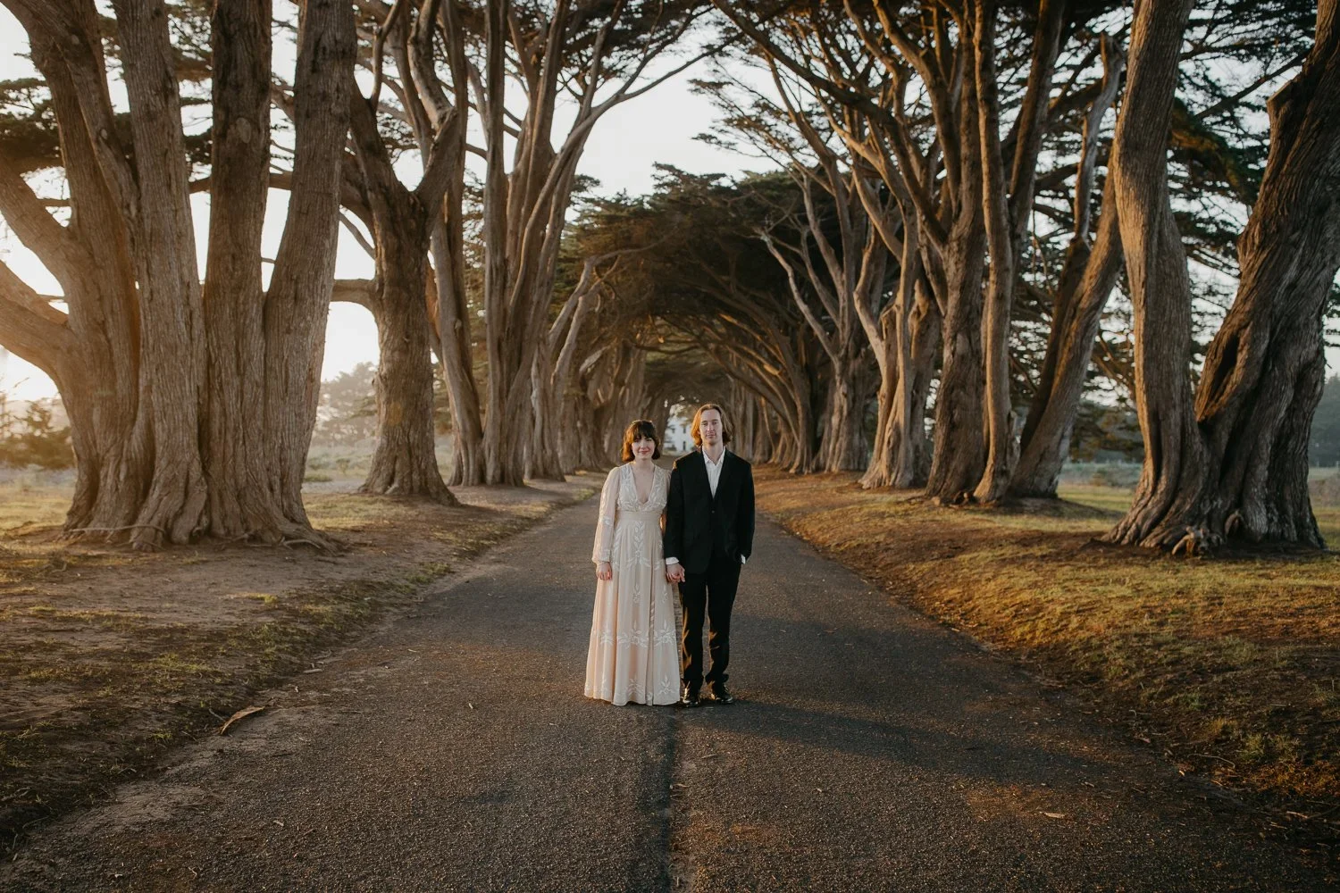 Couple holding hands in the Cypress Tree Tunnel at Point Reyes National Seashore during an intimate elopement