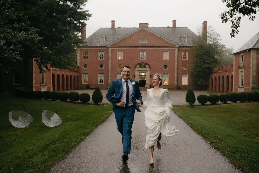 Bride and groom running together in front of Peterloon Estate in Cincinnati, Ohio