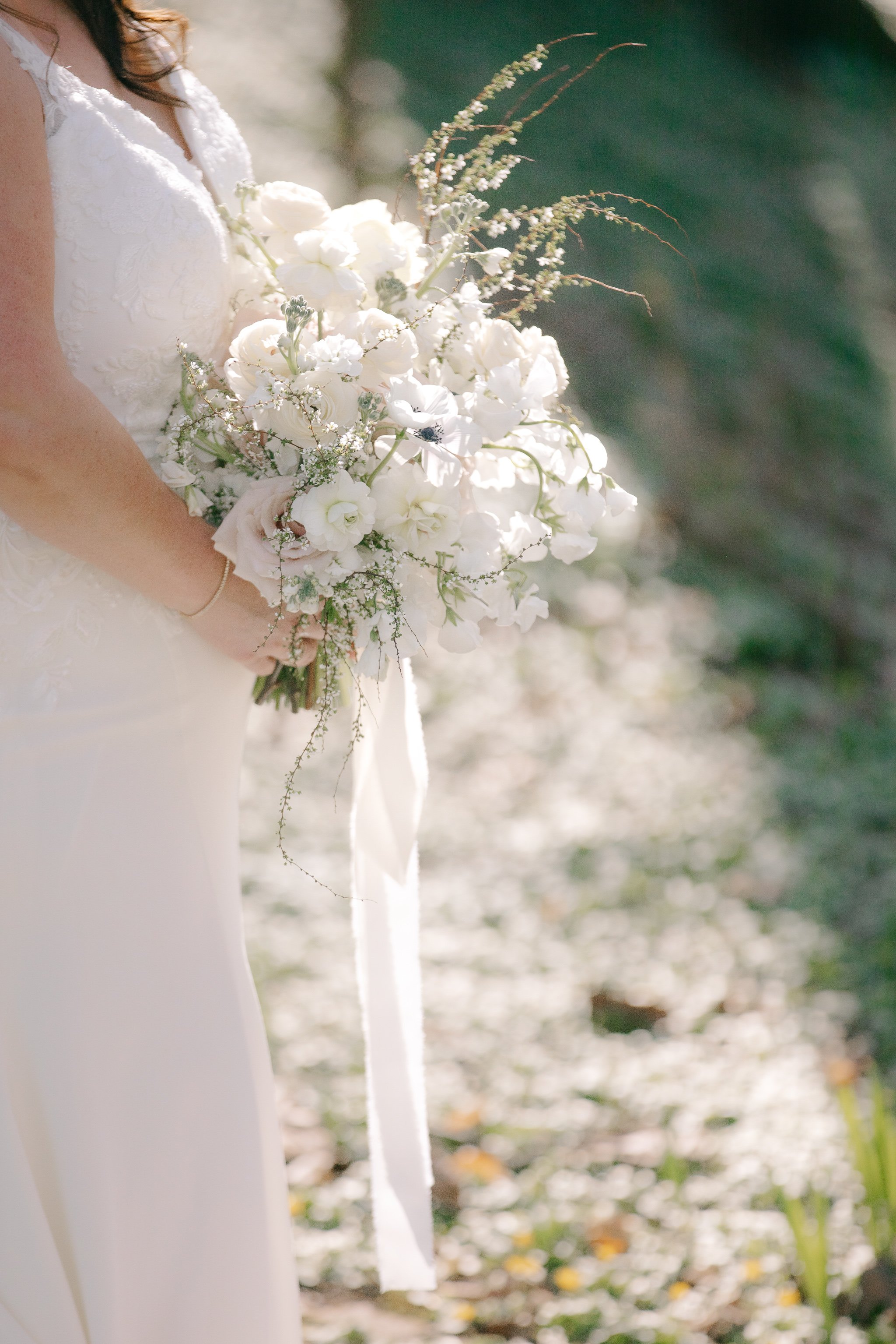 Close-up of soft white and blush bridal bouquet in natural light