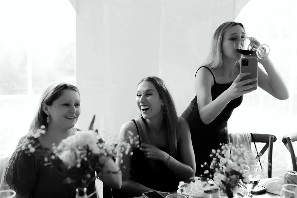 Wedding guests laughing together during a reception in the Hudson Valley