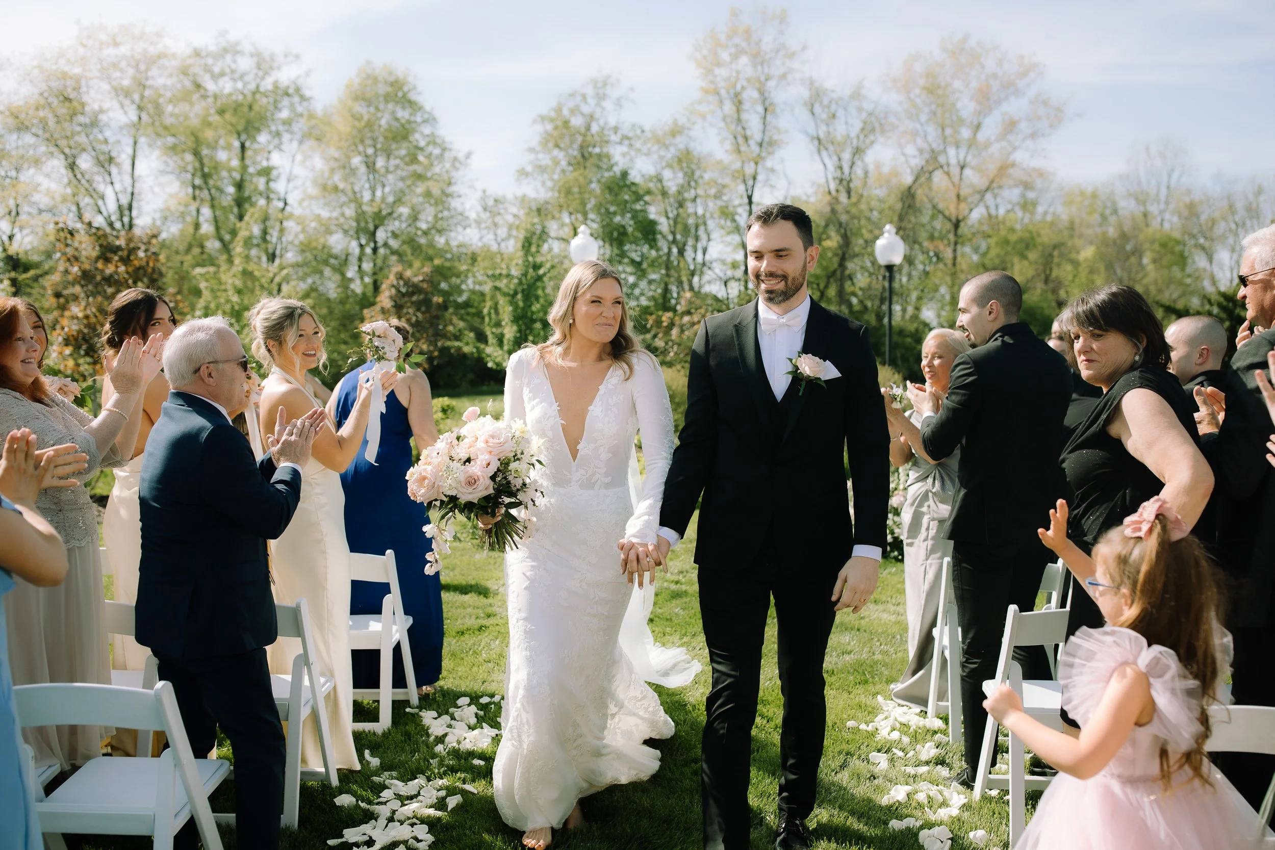Bride and groom walking down the aisle together after their outdoor ceremony at Jorgensen Farm The Gardens in Columbus, Ohio.