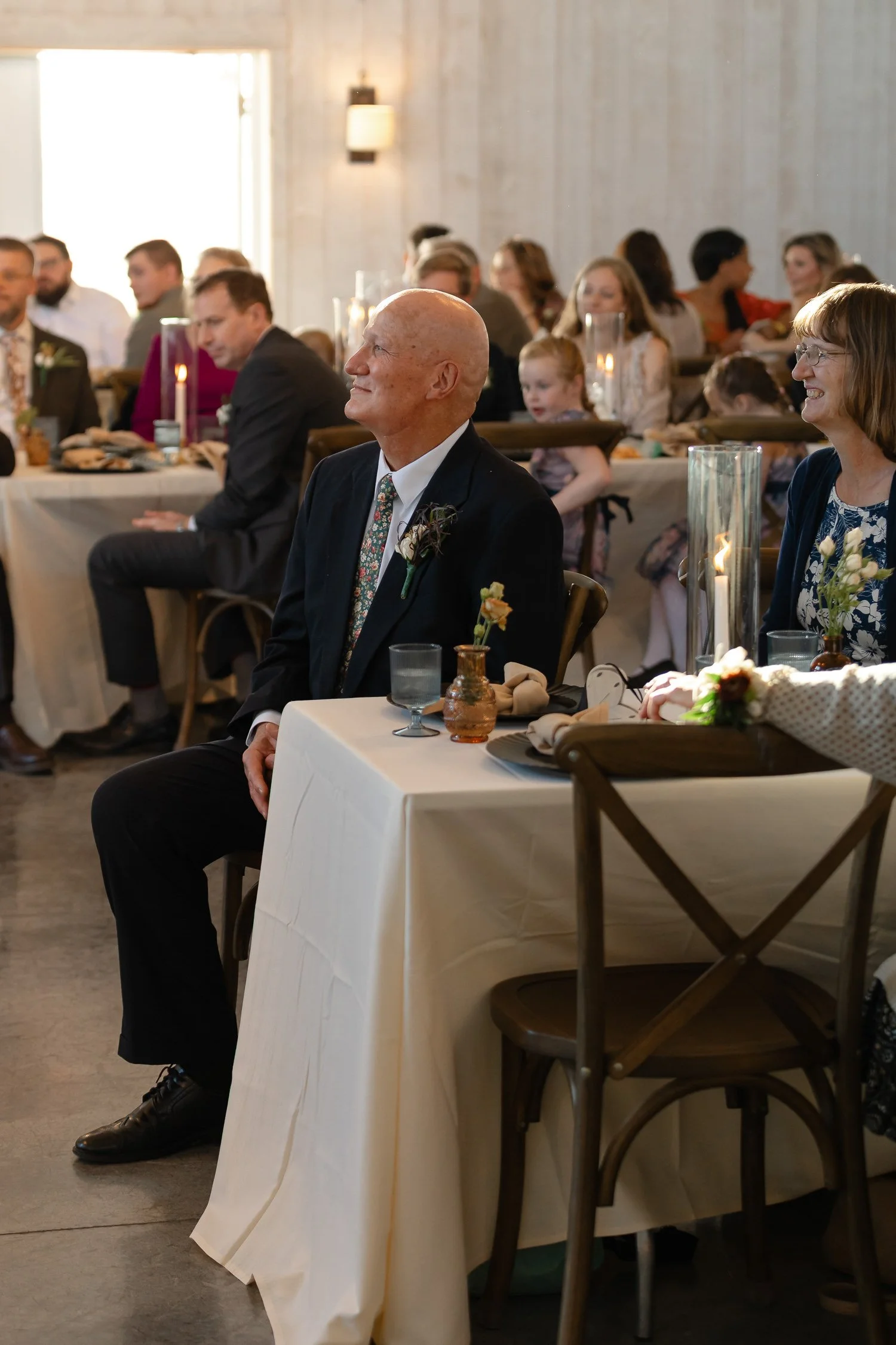 Parents watching reception events at an Ivory Meadows wedding in Dayton, Ohio.