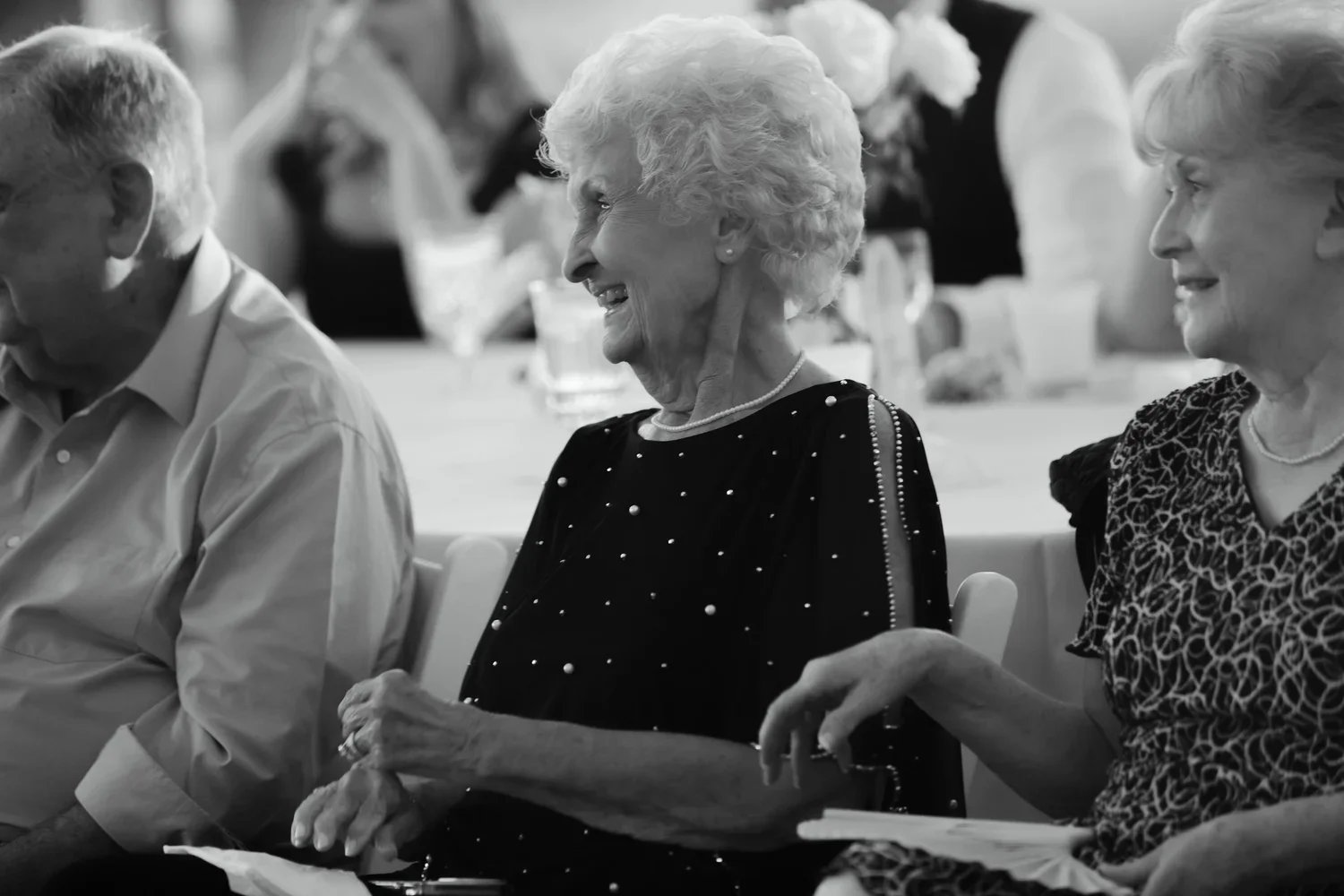 Candid wedding photo of grandparents laughing during ceremony, meaningful family moment