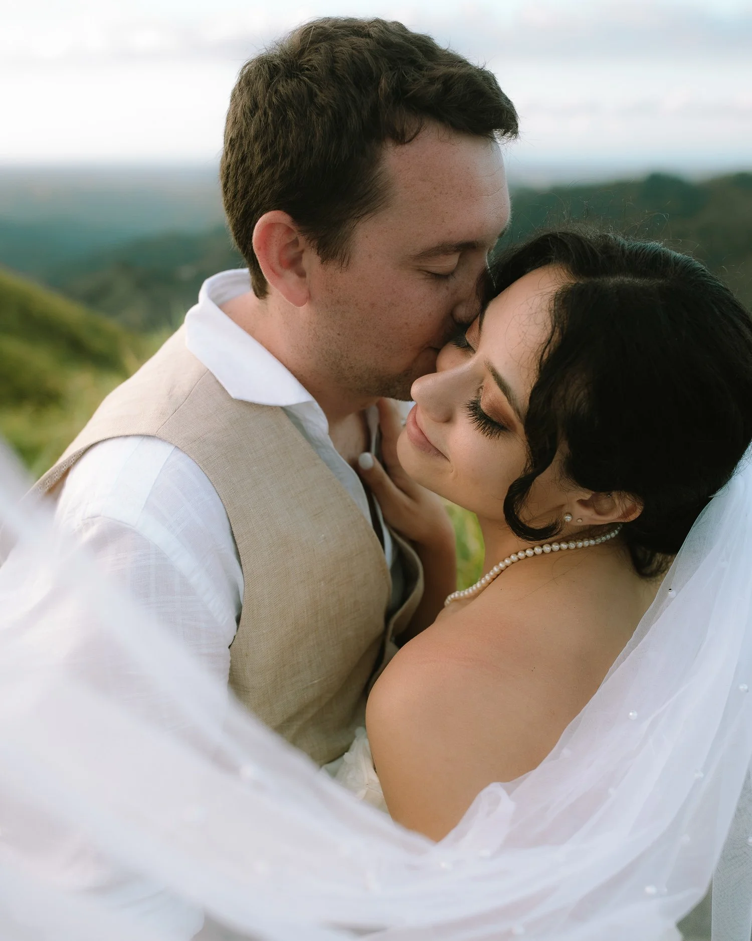 Couple holding each other in soft light during an elopement photo session at Cerro Mime