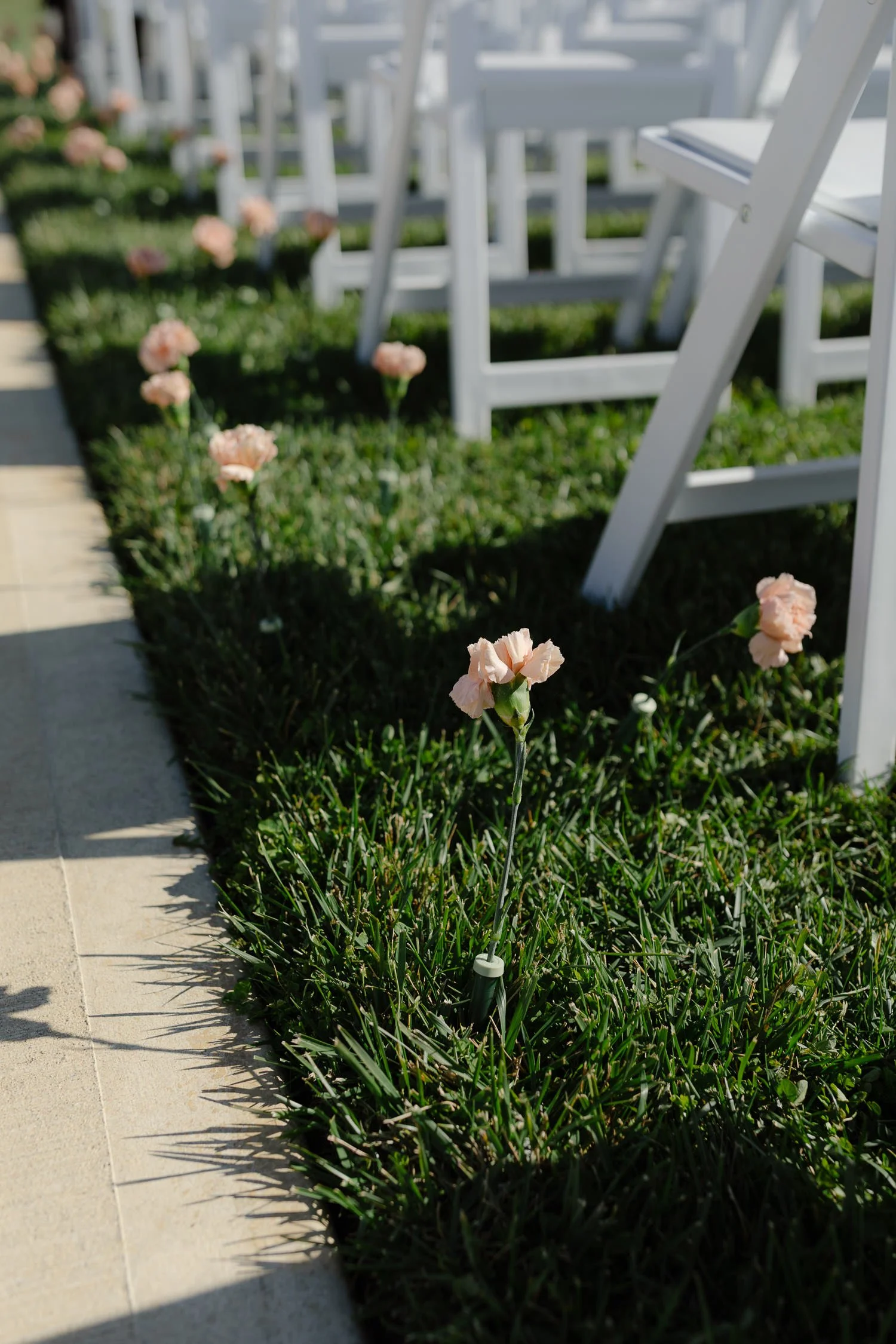 Soft floral accents lining the ceremony aisle during an outdoor Ivory Meadows wedding in Yellow Springs, Ohio.