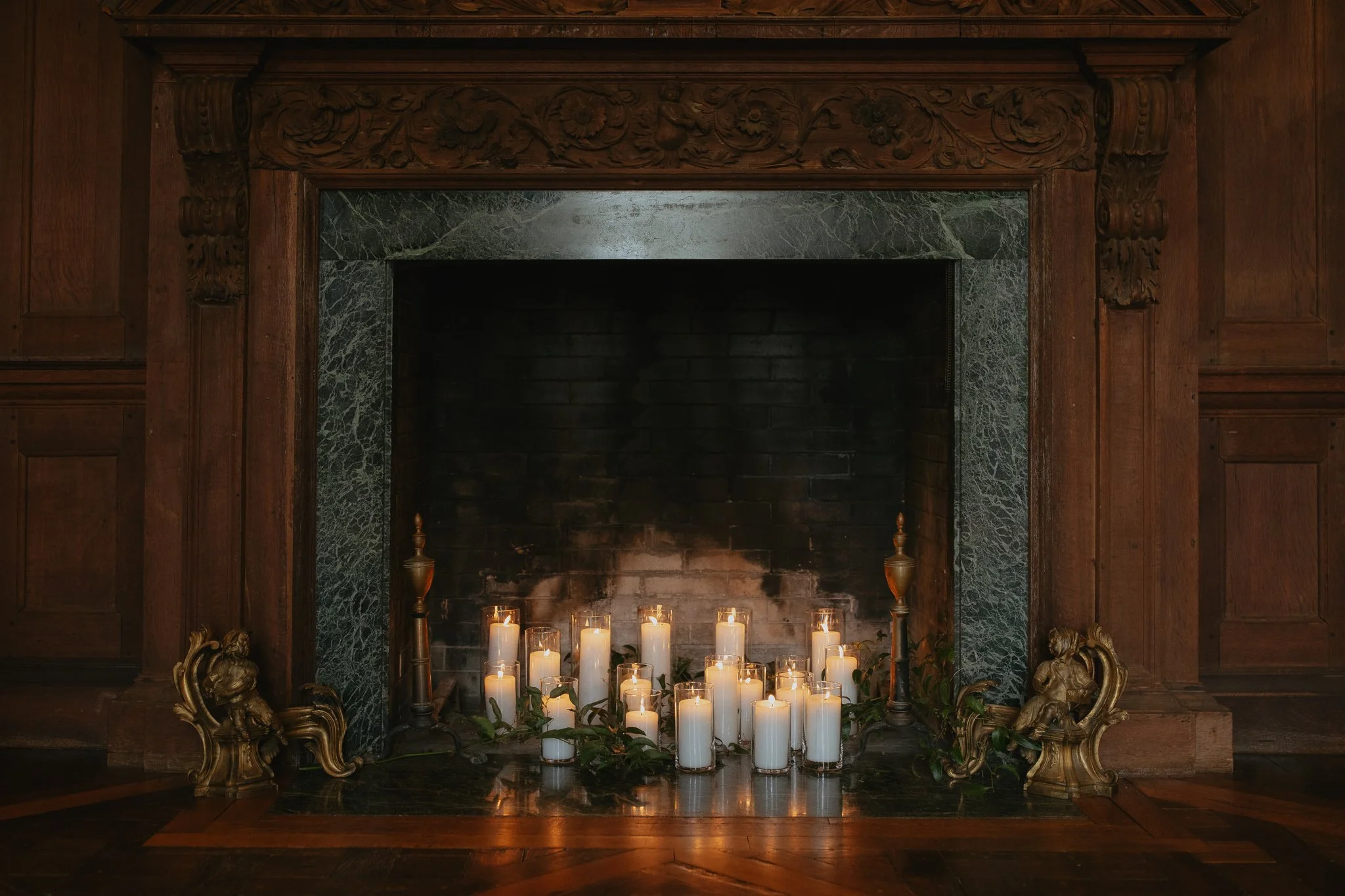Candles arranged in a carved wood fireplace inside Peterloon Estate during a Cincinnati wedding