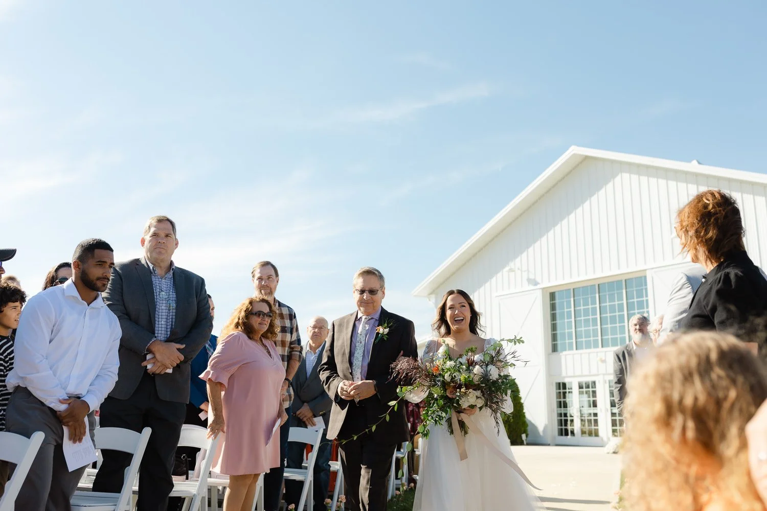 Bride approaching the ceremony site during an outdoor Ivory Meadows wedding in Yellow Springs, Ohio.