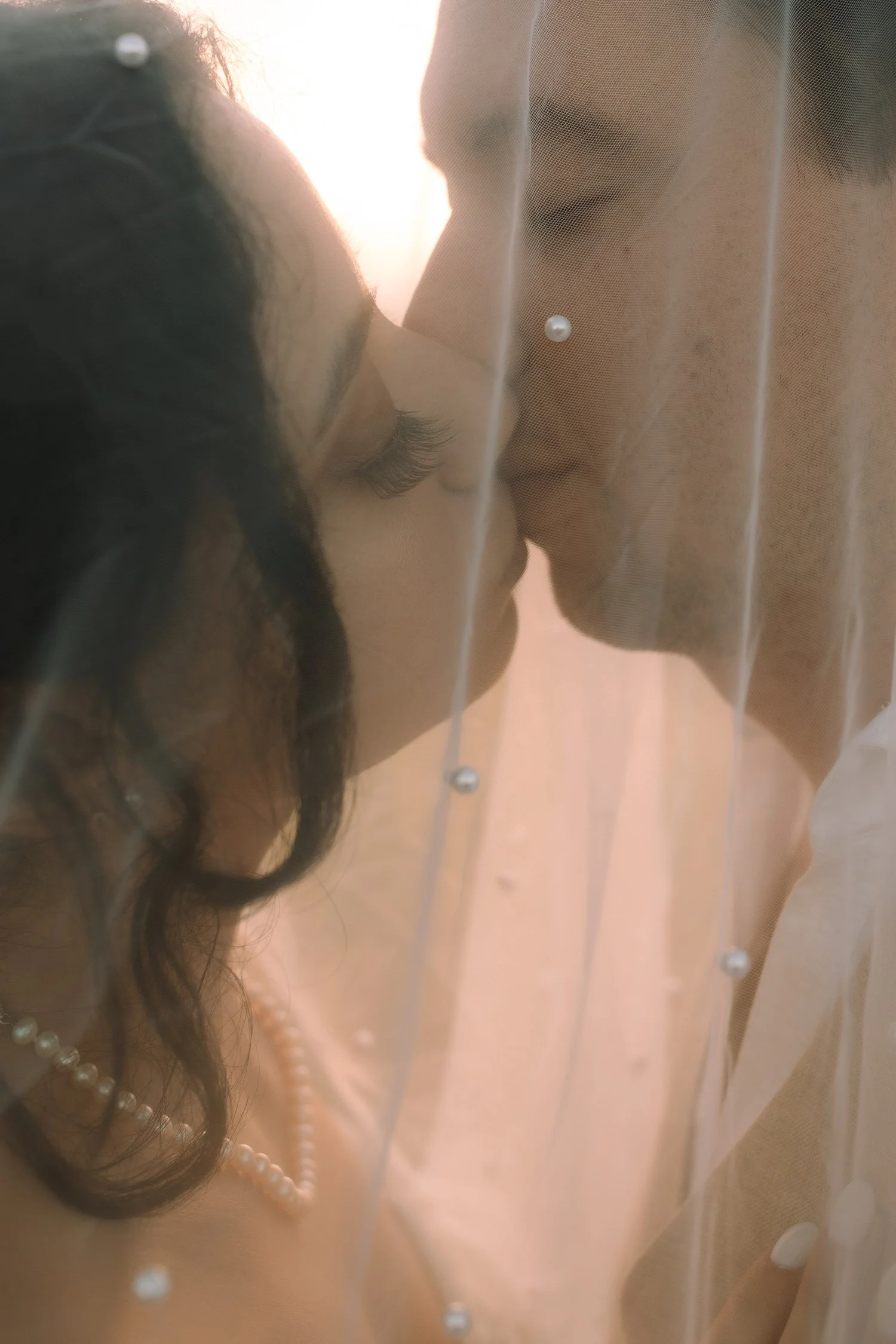Close up of a couple sharing a kiss through the veil during a Puerto Rico mountain elopement