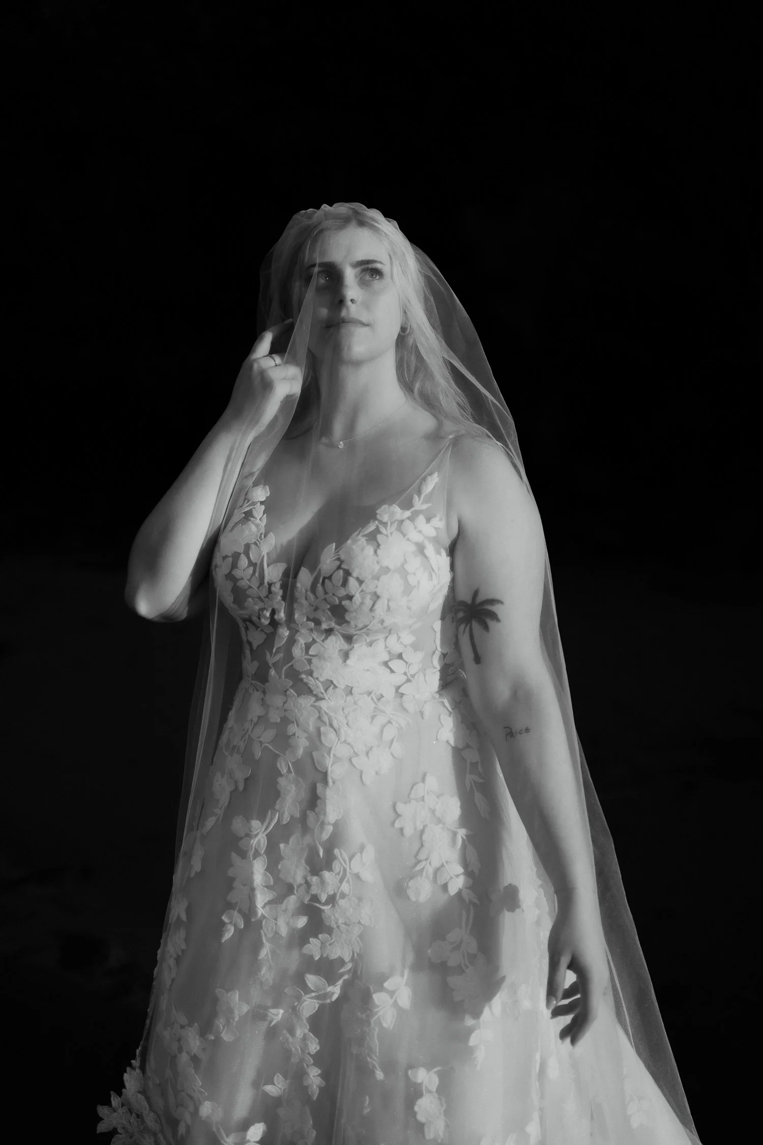 Close-up portrait of bride with veil contrasting shadow