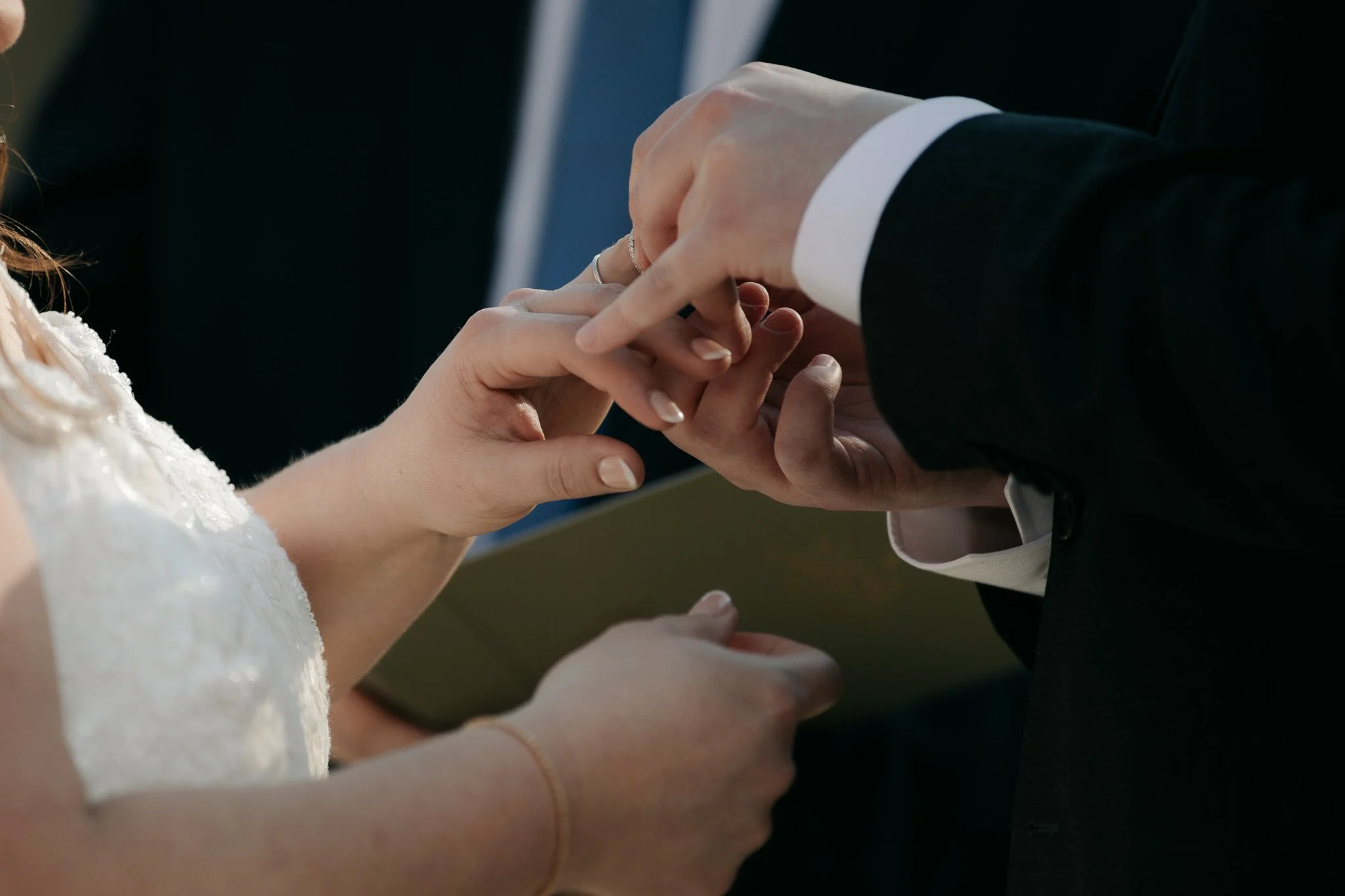Close-up of ring exchange during wedding ceremony