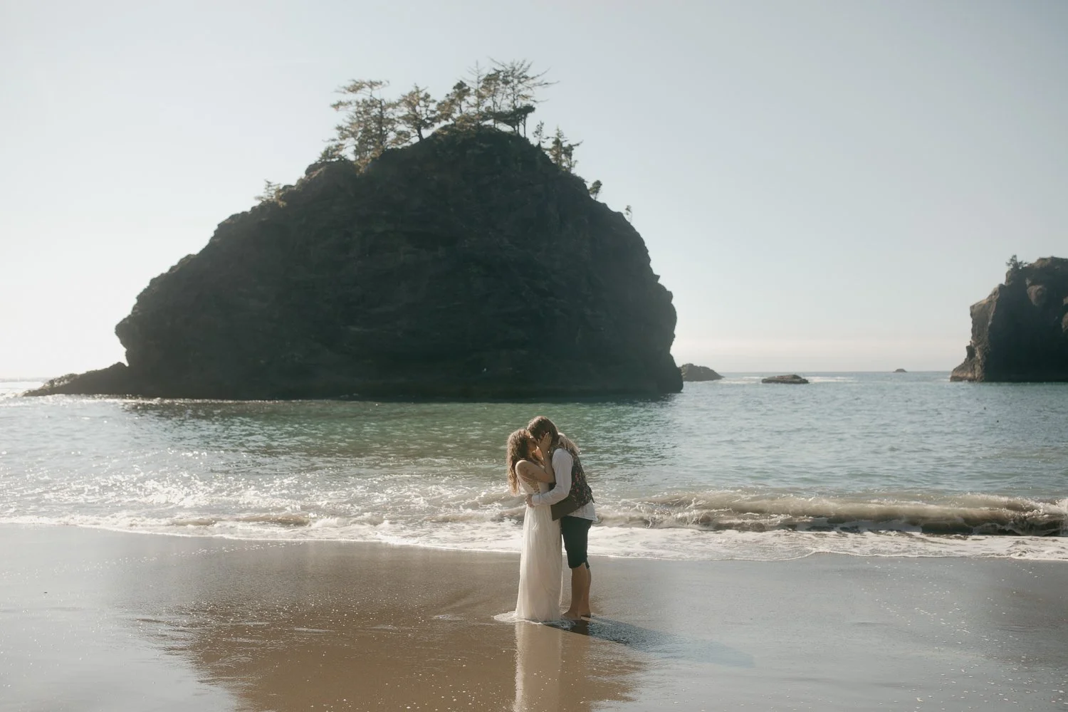Couple embracing in shallow water along the Samuel H. Boardman State Scenic Corridor