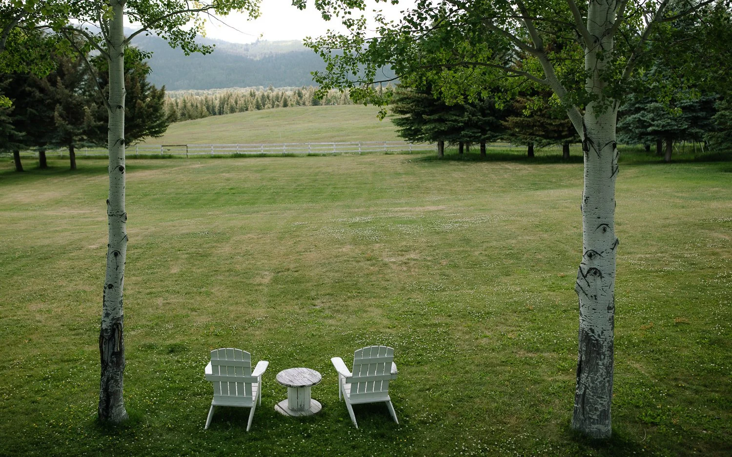 Quiet grassy lawn with Adirondack chairs and mountain views near Jackson Hole, Wyoming