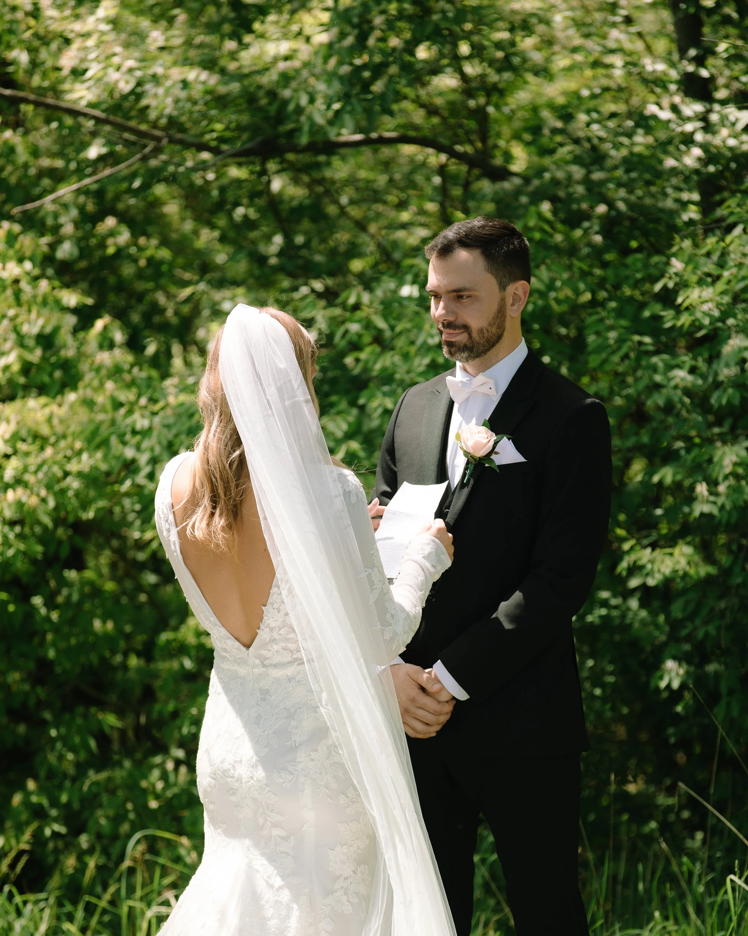 Bride reading her vows to the groom during a private moment in the gardens at Jorgensen Farm The Gardens in Columbus, Ohio.